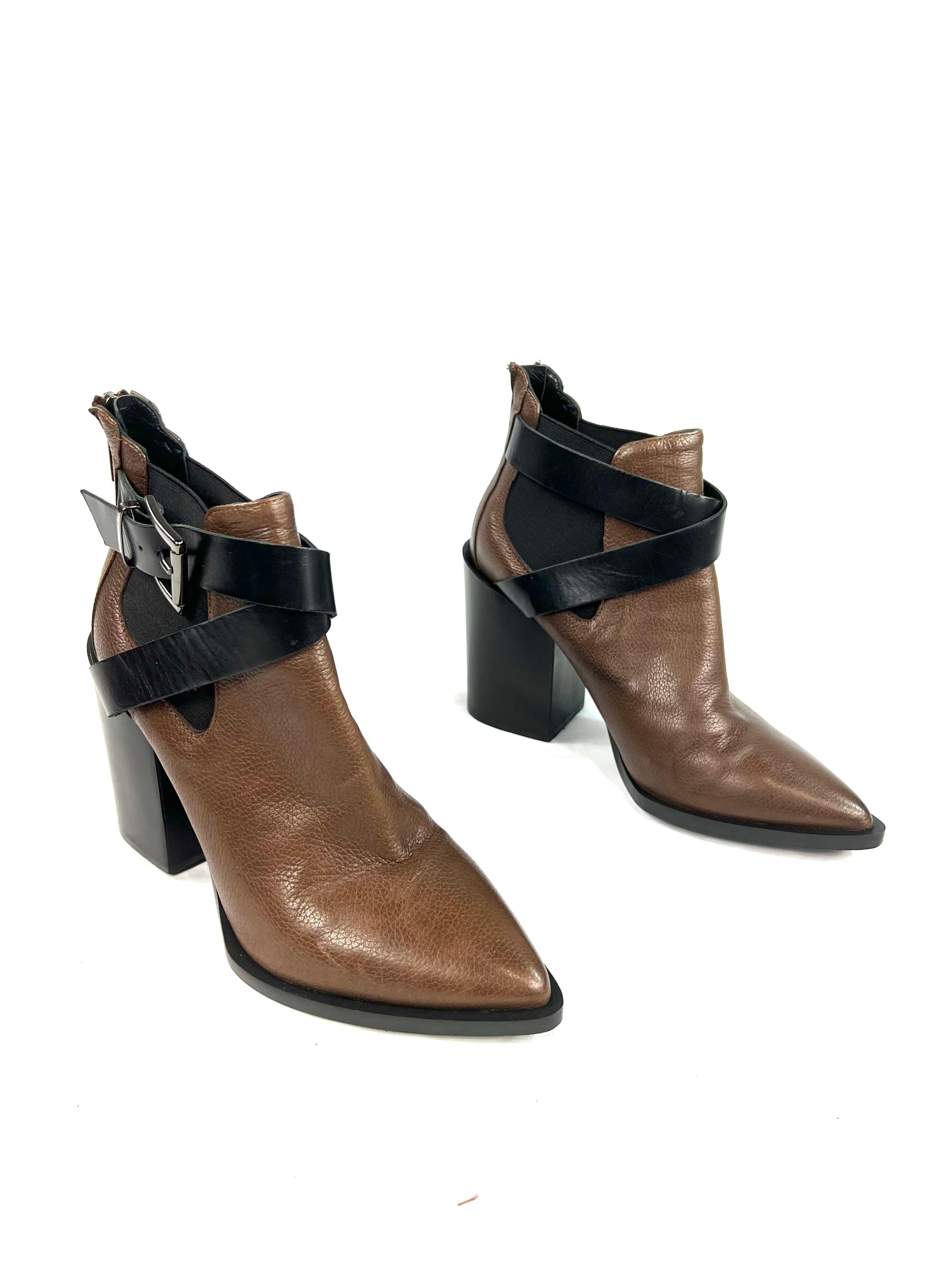 Product details:

The boots are made out of brown and black leather. It features silver tone side buckle detail, wide 4” high heel and rear zip closure. Comes with the original box.