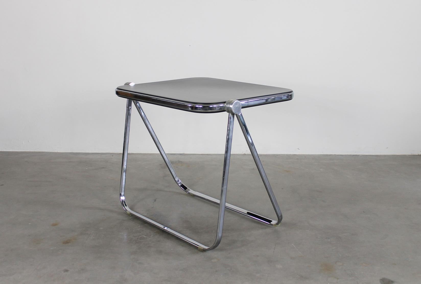 Platone folding table with structure in chromed steel and die-cast aluminum, table top in black polyurethane.
Designed by Giancarlo Piretti and produced by Anonima Castelli in 1970s, Italy. 
Platone table is part of the permanent design collection