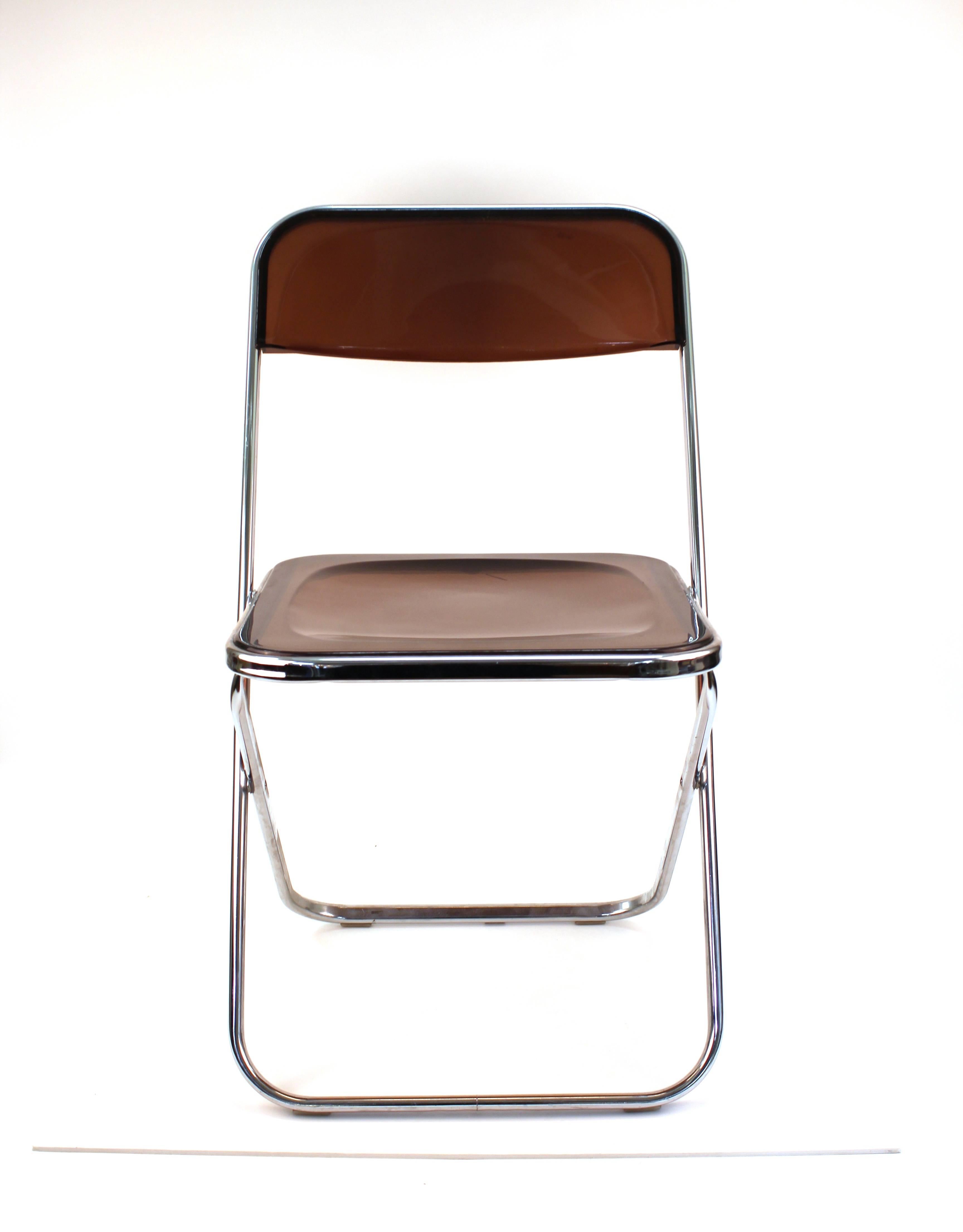 Giancarlo Piretti 'Plia' style folding chairs set of four, in smoked Lucite. The set was made in Italy in the 1970s and is in good vintage condition with age appropriate wear to the Lucite.