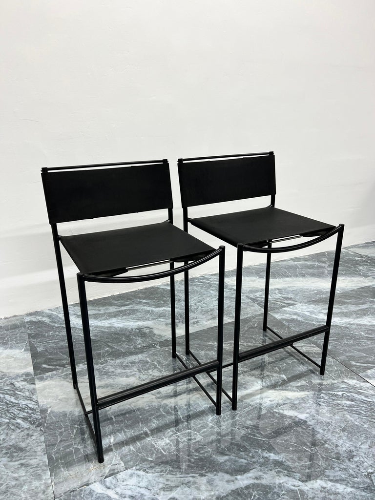 Pair of postmodern black powdercoated steel frame with black leather seat and back counter height stools designed by Giadomenico Belotti for Alias, 1980s.