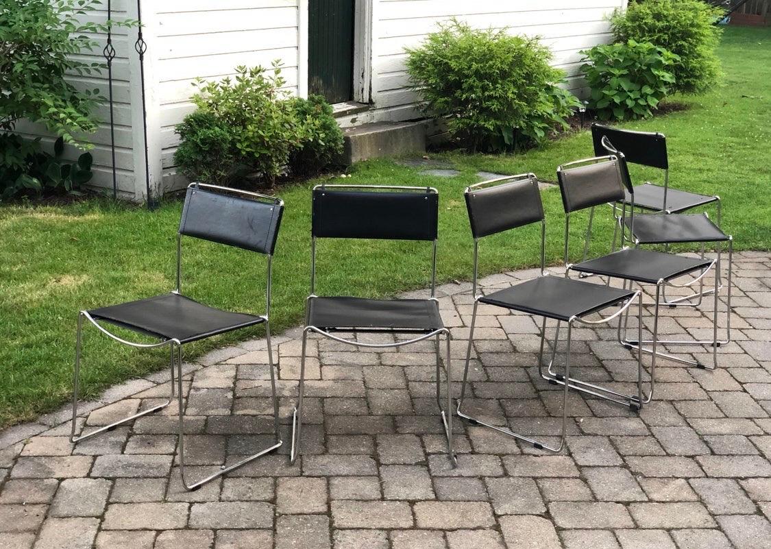 Belotti chrome and metal dining chairs for Alias, circa 1980s. Great Minimalist design, lines and scale.
Heavy construction so they are very sturdy and they stack. The have some wear to them and the vinyl supports would need to be replaced in the
