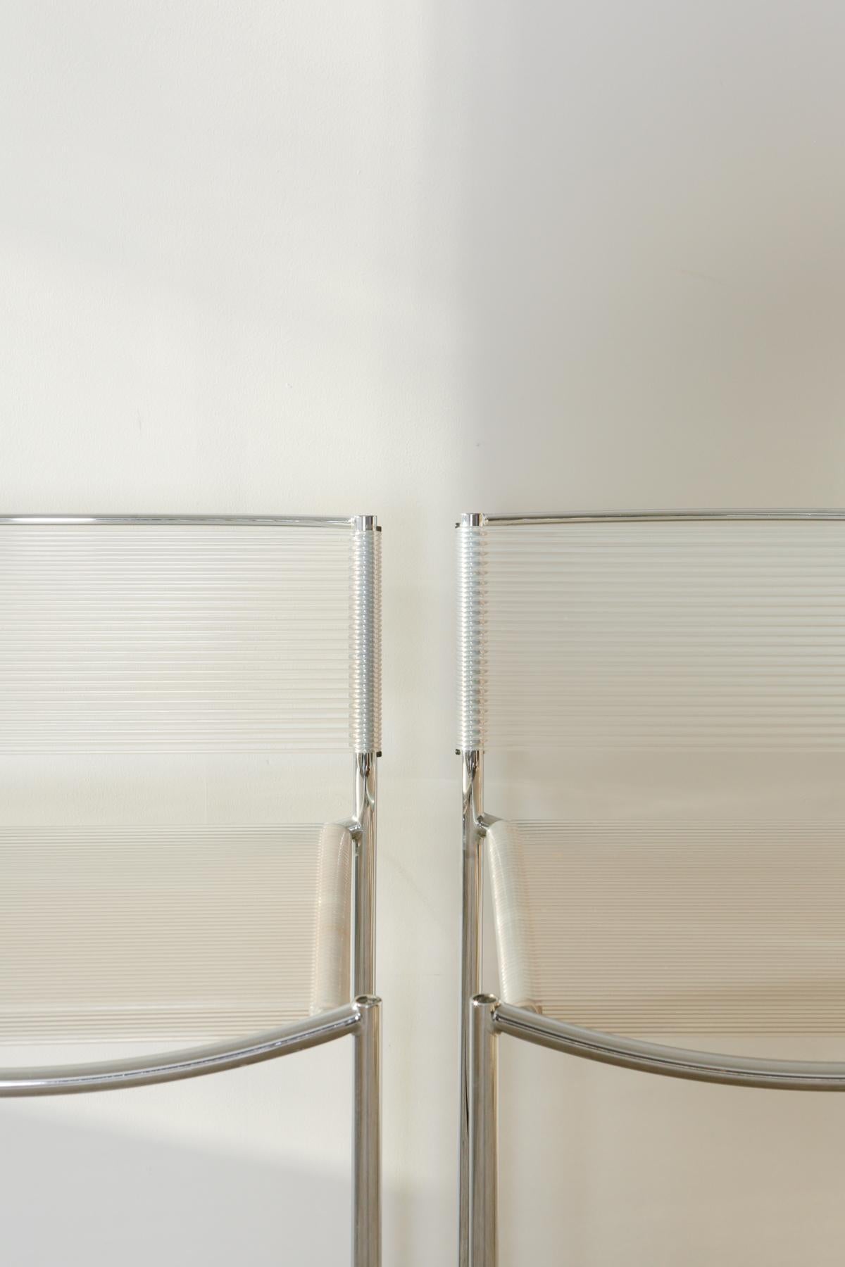 Spaghetti stools, designed by Giandomenico Belotti for Alias in circa 1980s. Spaghetti is the first Alias chair to appear in the MoMA collection of New York. The frame is bright silver enameled steel, while the backrest and the seater is transparent