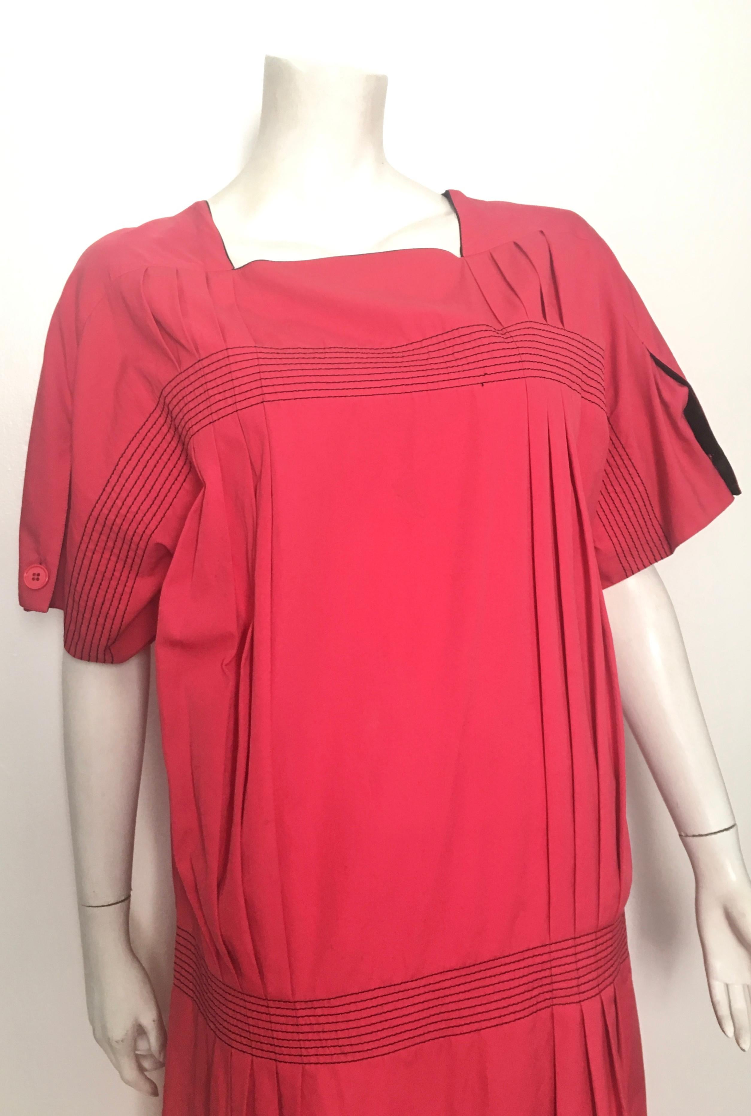 Gianfranco Ferre 1980s cotton loose fitting cut short sleeve dress is an Italian size 42 and will fit a size 6 / 8.  This design is reminiscent of a 1920s design that was meant to be big and boxy.   Gorgeous salmon red color with pleats adds a real