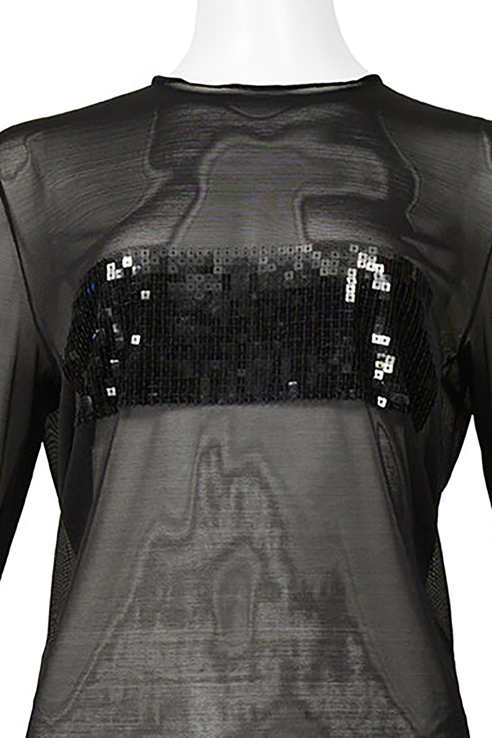 Resurrection Vintage is excited to offer a vintage Gianfranco Ferre black mesh top featuring a black square sequin front panel at the bustline, long sleeves, and straight body.

* Gianfranco Ferre Label
* Size Label Missing. Today's size S-M or