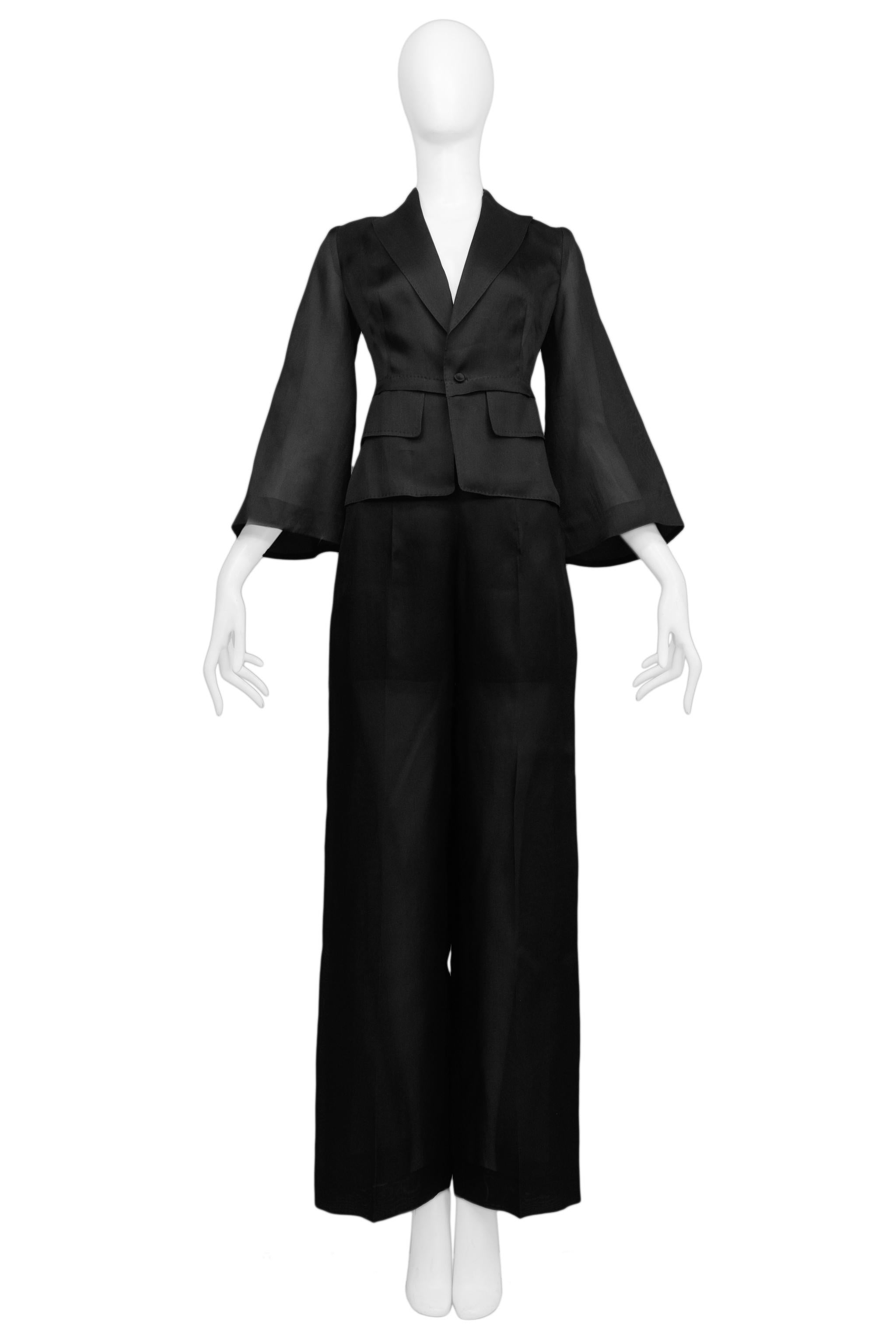Resurrection Vintage is excited to offer a vintage Gianfranco Ferre sheer black pantsuit featuring a fitted jacket with a slightly high waistline, sharp lapels, 3/4 flared sleeves, one-button closure, and pocket flaps. The pants feature a paneled