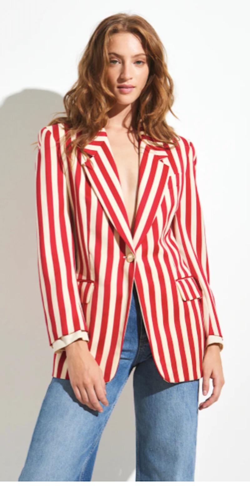 Playful red and white striped blazer with faux shirt sleeves at cuffs and strong gold buttons. 
Shoulders 16 in
Bust 36 in
Waist 32 in
Length 29 in
Sleeve 24 in
Marked Size US 6
Good Vintage Condition. Can accommodate sizes XS-M. 
Model is 5 ft 9.5