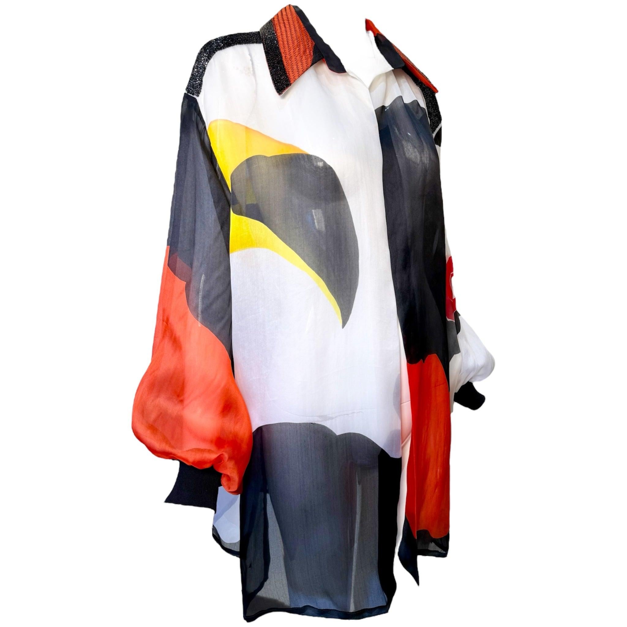 1990's Gianfranco Ferre silk organdy blouse with bold red, black, yellow, and white abstract print. Open front blouse, no closure. Black chevron stitching and beading on red collar. Bishop sleeves. New with tags, unworn.

Additional