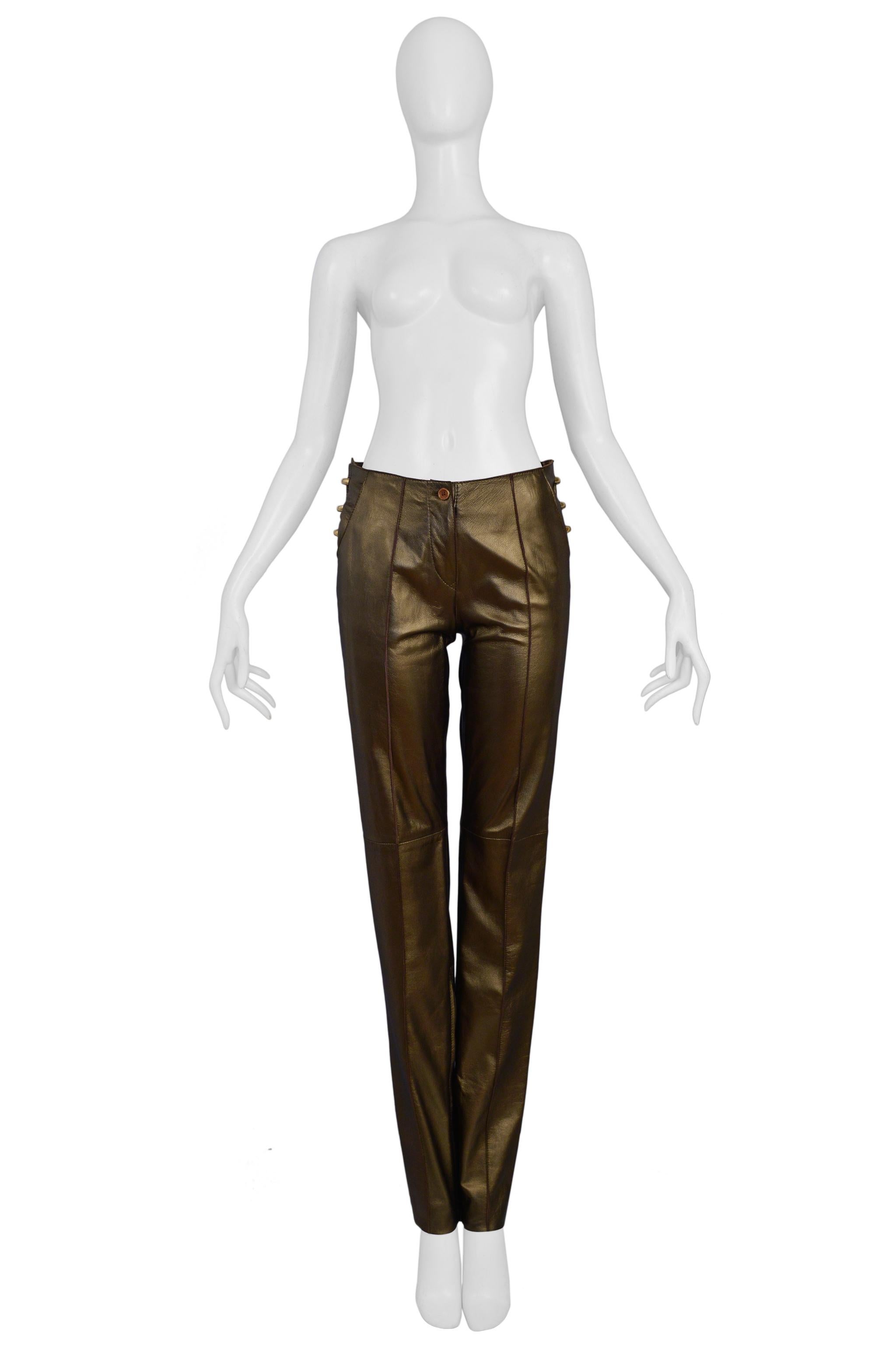 Resurrection Vintage is excited to offer a vintage pair of Gianfranco Ferre bronze lambskin leather pants featuring a center front zipper and button, large brass side hardware, ankle zippers, front and back pockets, and slim fit.  

Gianfranco