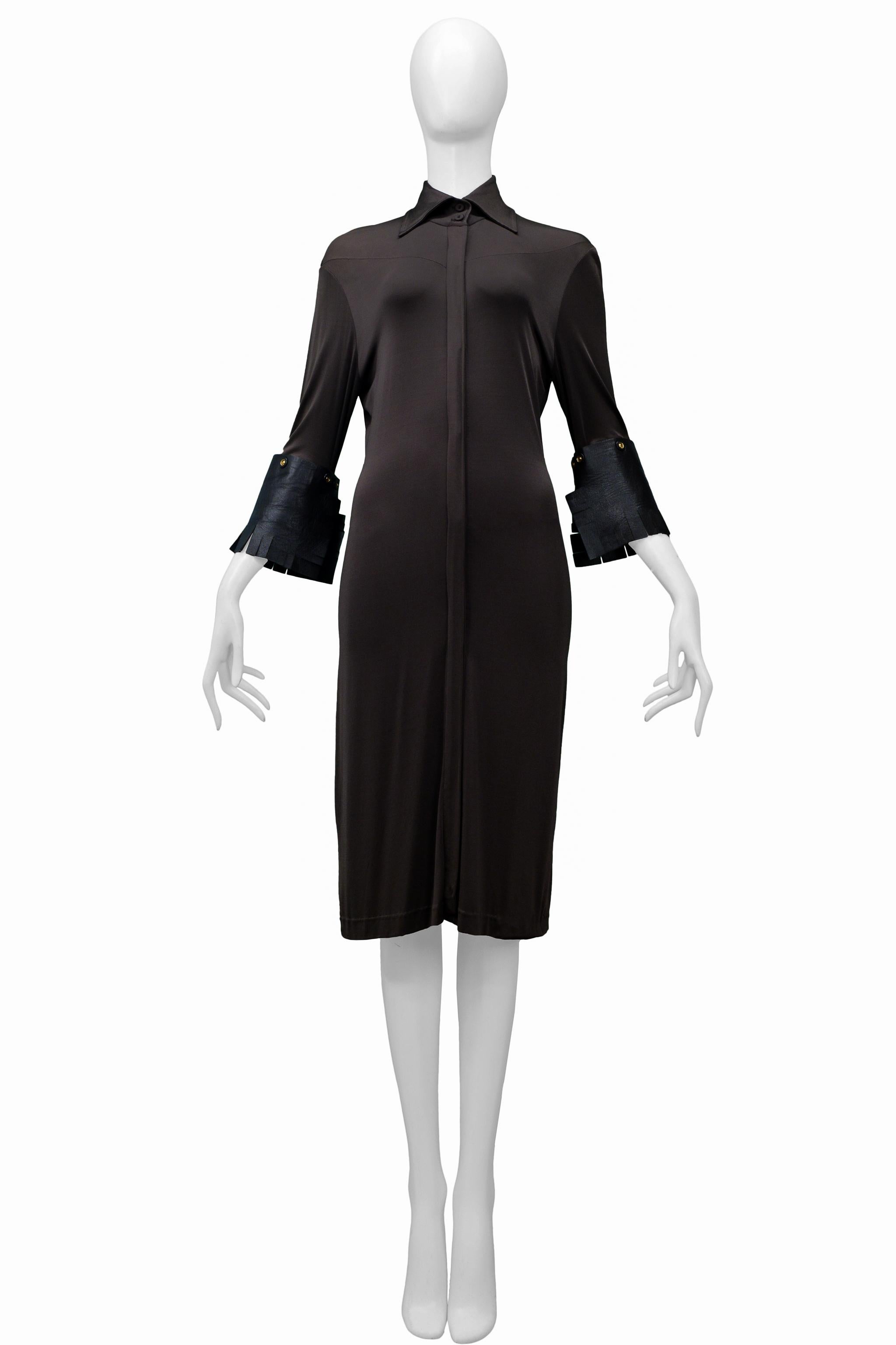 Resurrection Vintage is excited to offer a vintage Gianfranco Ferre brown jersey dress featuring decorative gold buttons, large leather cuffs with fringe, front placket, and folding collar. 

Gianfranco Ferre
Size S/M
95% Jersey, 5% Elastic,