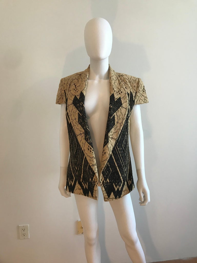 Beautiful Gianfranco Ferre Vintage Geometric Pattern Laser Cut Cap Sleeve Jacket. Beige and Black detailing, Made in Italy. Open Front. Size 44 Italian. Manufactured by Dei Mattioli