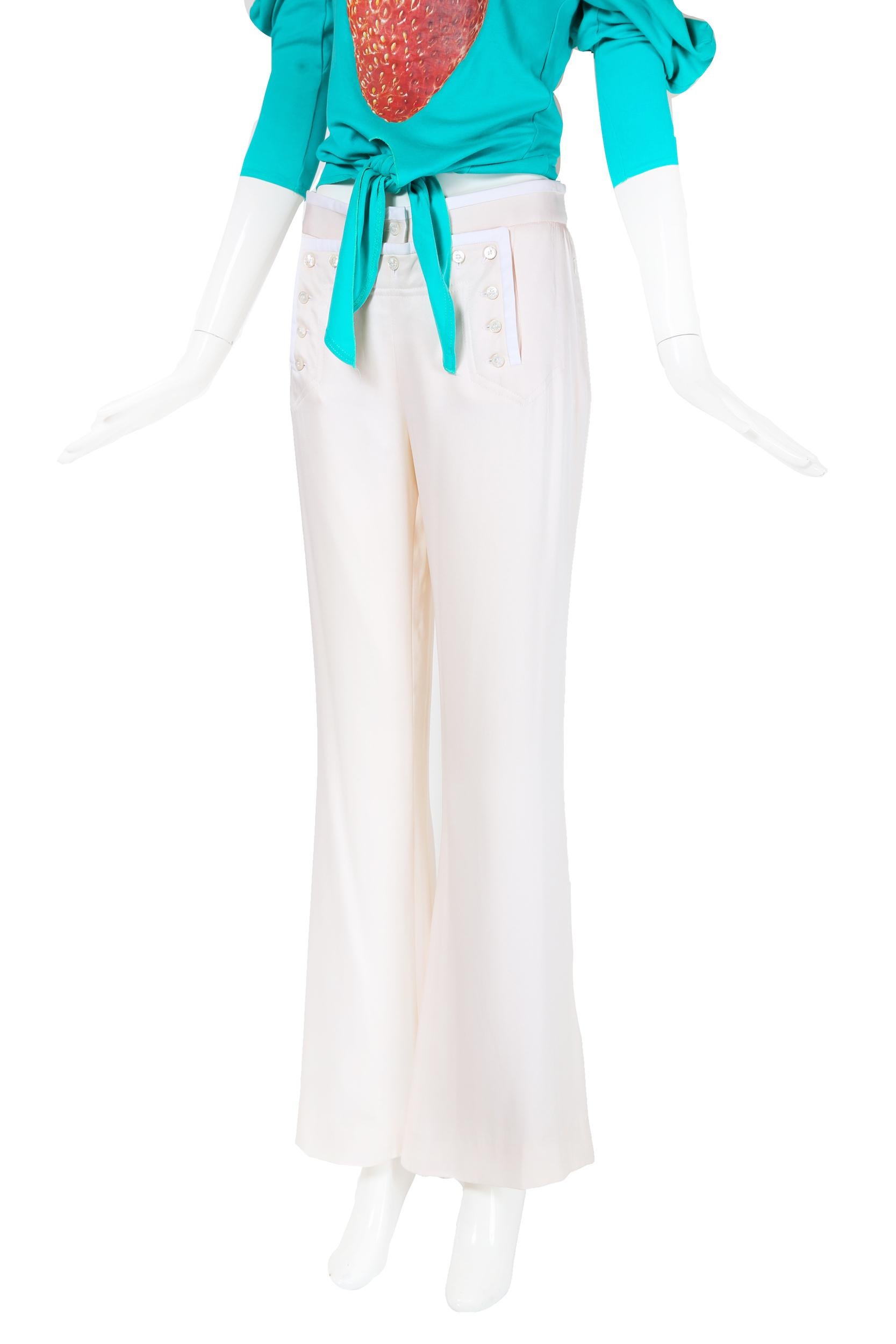 Gianfranco Ferre creme-colored silk pants with a configuration of pearlescent frontal button closures that are reminiscent of sailor pants. Features hidden zipper closure side pockets, white trim at the waist band, frontal buttoned flap and a pant