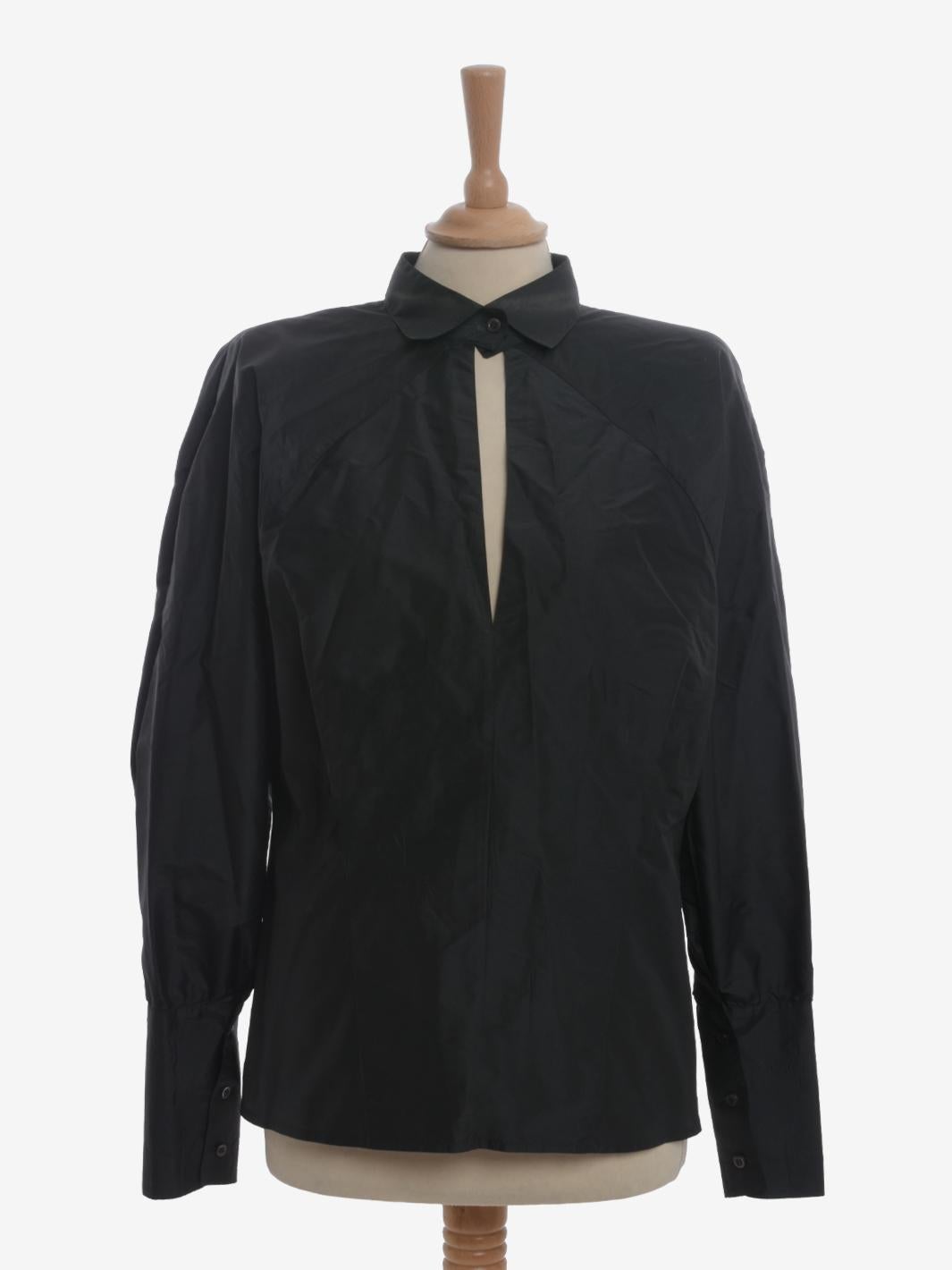 Gianfranco Ferré Cut-out Shirt is a rare garment from ferrè featuring padded shoulder pads and a slouchy cut. the sleeves have adjustable button cuffs and the closure is a single button under the collar. Giving the garment particularity is the