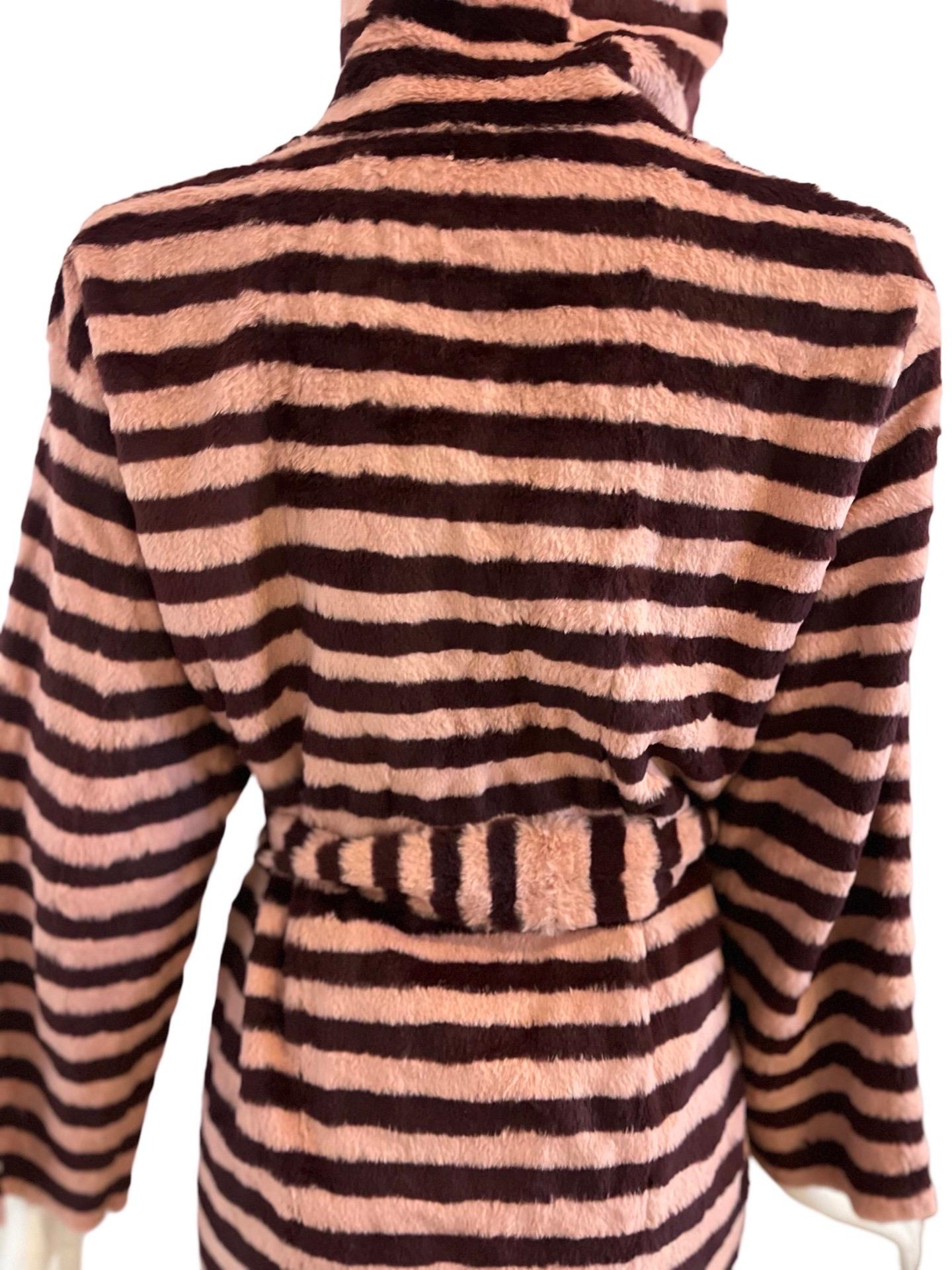 90s Gianfranco Ferre Fourrures incredible striped fur coat in pink and burgundy stripes. The inside is not lined and so is a suede texture and you can see the construction. 

The coat is belted and has a hood! The fur belt is held on with pink