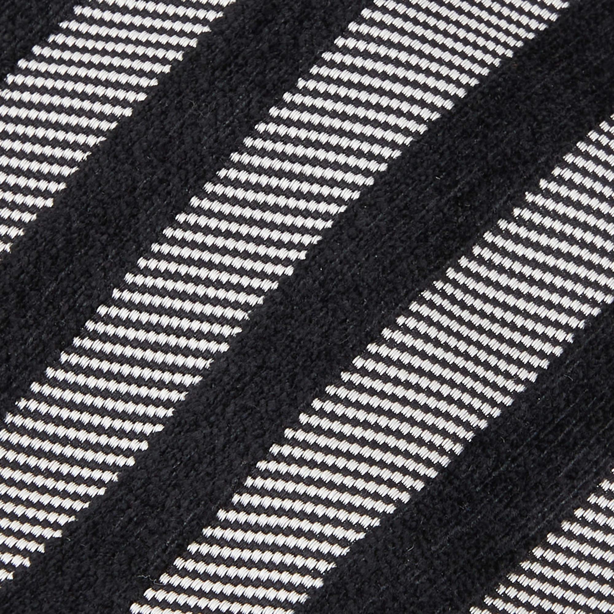 This Gianfranco Ferre tie is a perfect formal accessory that has a sharp and modern appeal. Made from silk  it features a grey and black shade  diagonal stripe  and the brand label neatly stitched at the back. It is sure to add oodles of style to