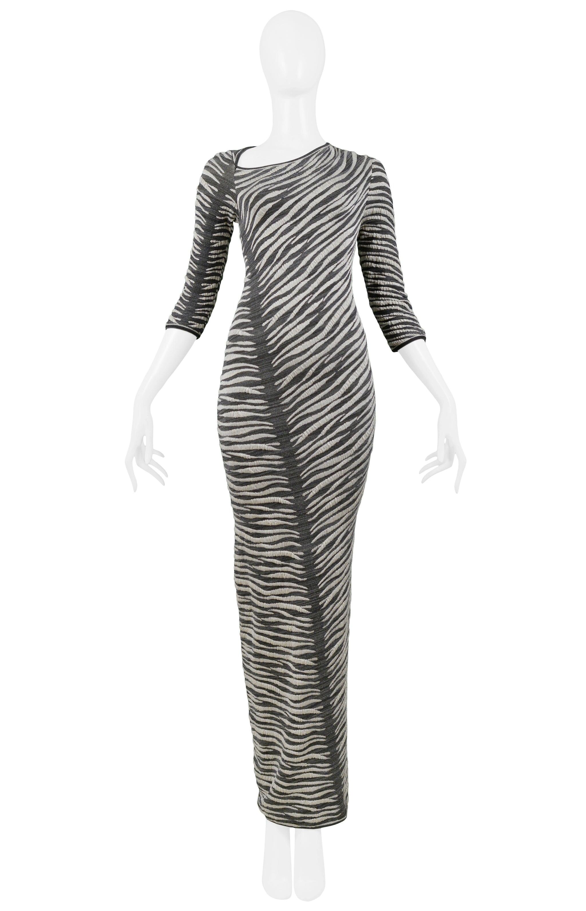 Resurrection is pleased to offer this vintage Gianfranco Ferre grey and white embroidered zebra stripe maxi dress featuring an asymmetrical neckline, three-quarter length sleeves, and diagonal stitch detail down the center back to the