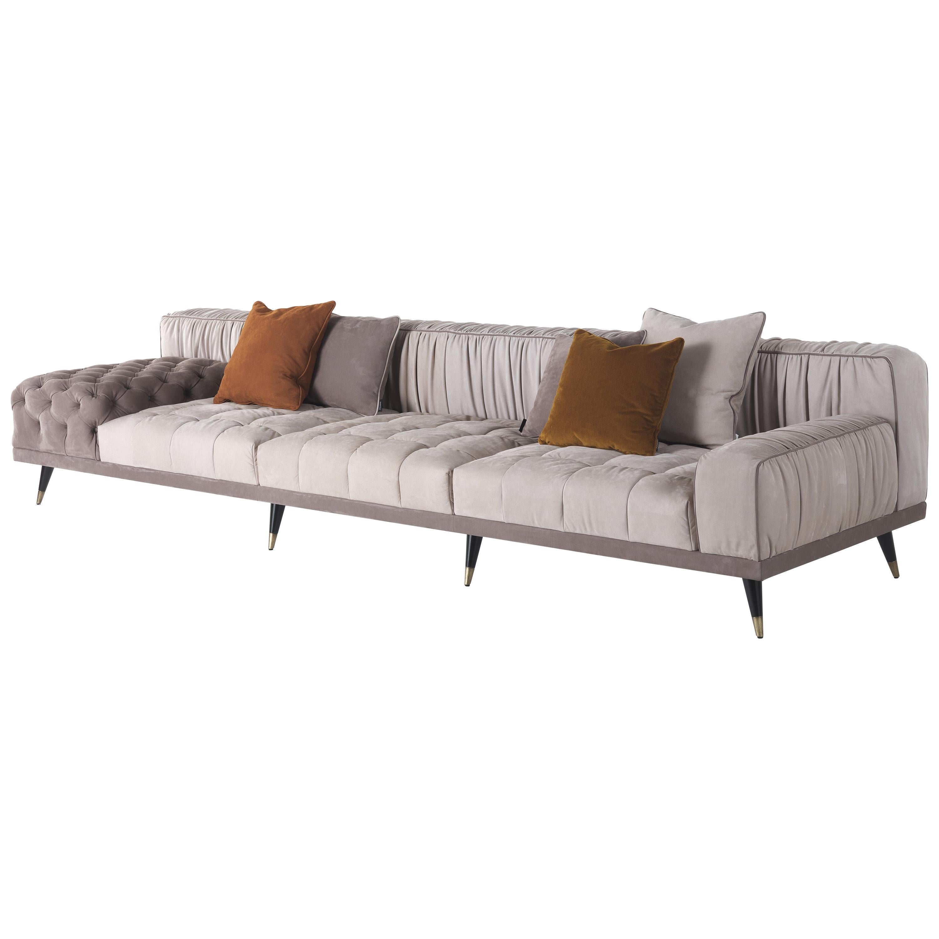 A sofa with a bold personality that combines essential design, contemporary lines and a high level of craftsmanship. The alternation between different finishings, with capitonné parts and pleating on the back, creates a unique and refined set that