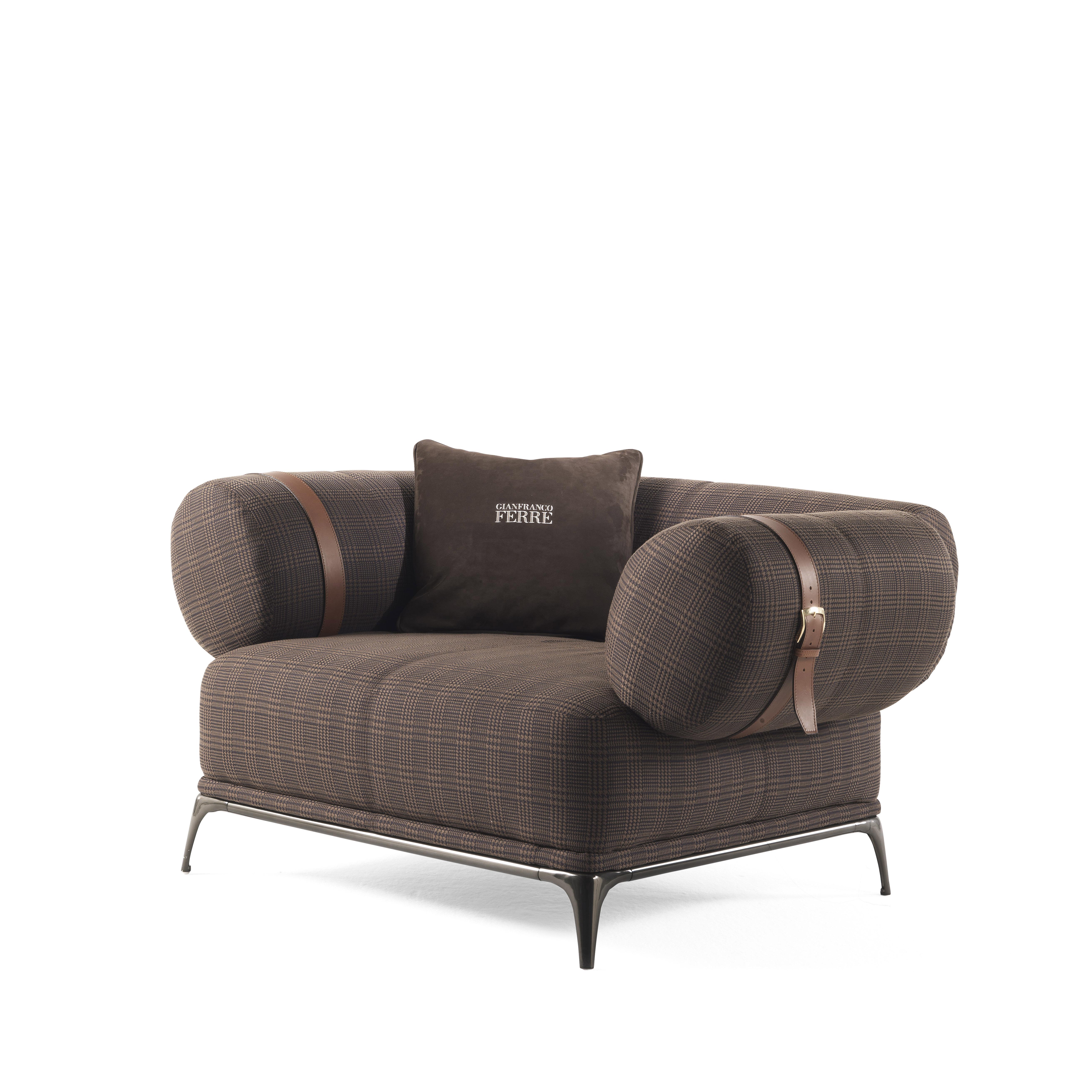A revisited vintage style for the Phoenix armchair, featuring armrests and backrest with oval section, slightly inclined outwards and upholstered in brown and black Prince of Wales fabric. The reference to Gianfranco Ferré heritage, present in the