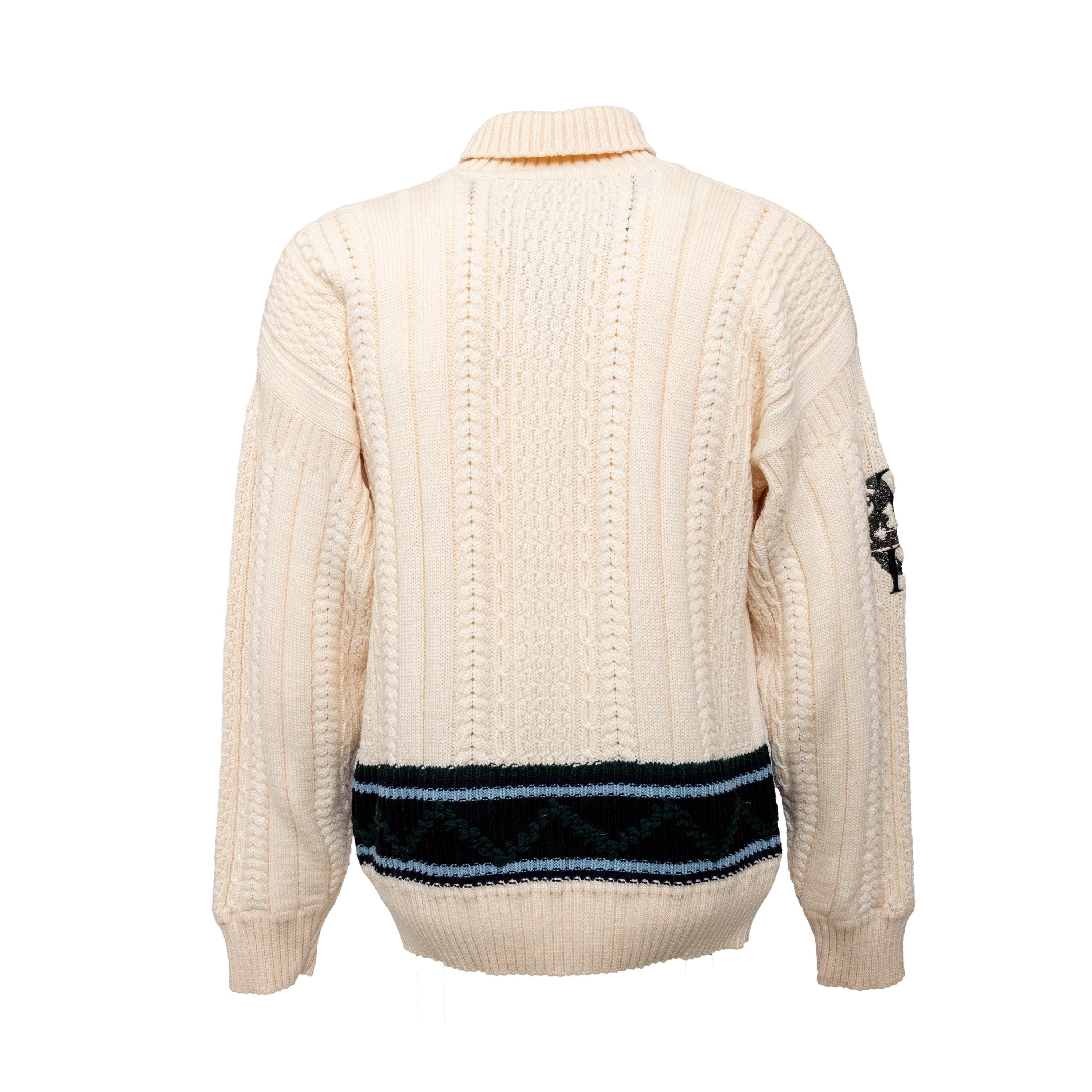 Expertly crafted by Gianfranco Ferré, this 90s knit sweater is a cozy and stylish staple for any wardrobe. Made from luxurious virgin wool with intricate cable stitch patterns and a unique reversed embroidery on the right arm, this sweater also