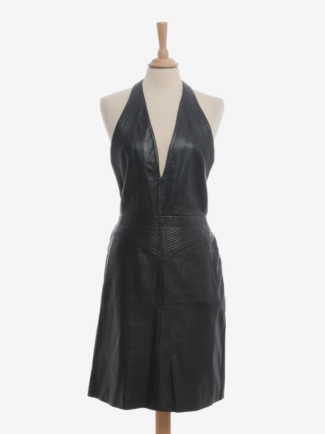 Gianfranco Ferré Leather Midi Dress is a rare Ferrè garment from the 1980s made of very soft leather and decorated with stitching, especially at the waist creating a shape that define the silhouette. V-neckline with lacing behind the neck that