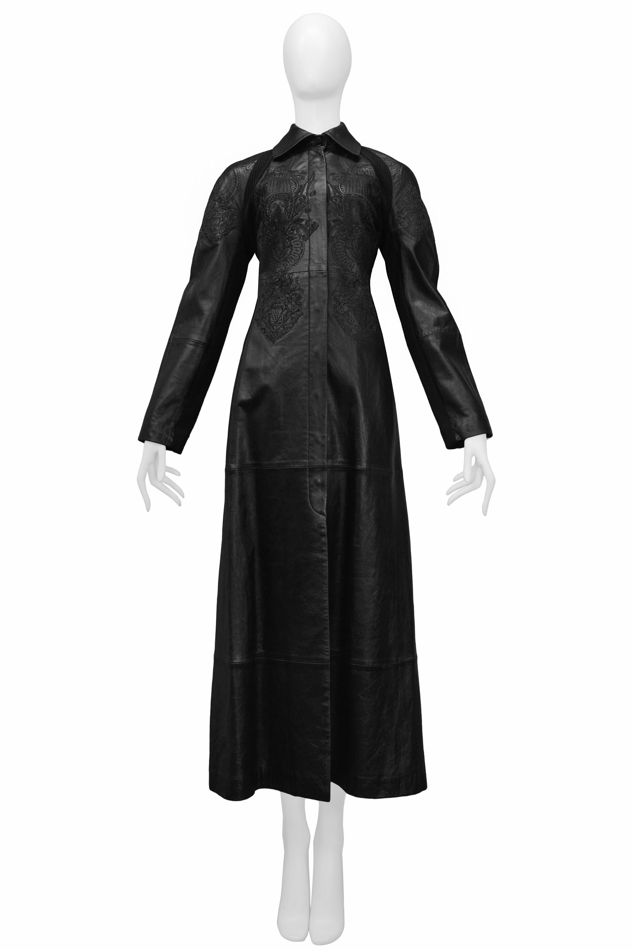 Resurrection Vintage is excited to offer a vintage Gianfranco Ferre black leather and knit maxi coat featuring fancy embroidery, knit insets and back panel, herringbone trim, hidden snaps placket, folding leather collar, and maxi-length.