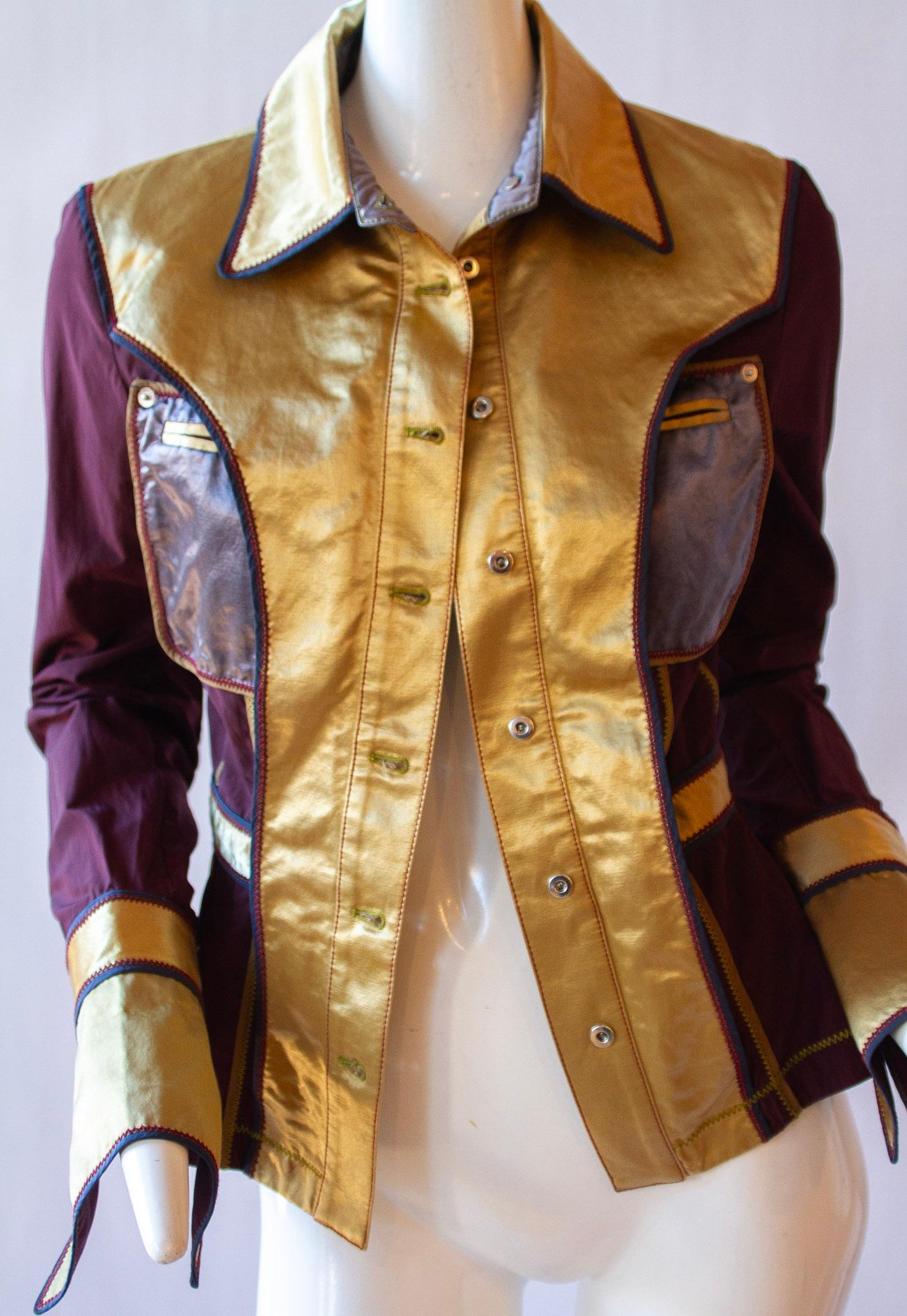 This Gianfranco Ferre jacket combines a metallic maroon pattern with rivet detailing on the elbow pads for an eye-catching, fashion-forward look. Genuine Italian craftsmanship and top tier quality fabric ensure a premium feel.