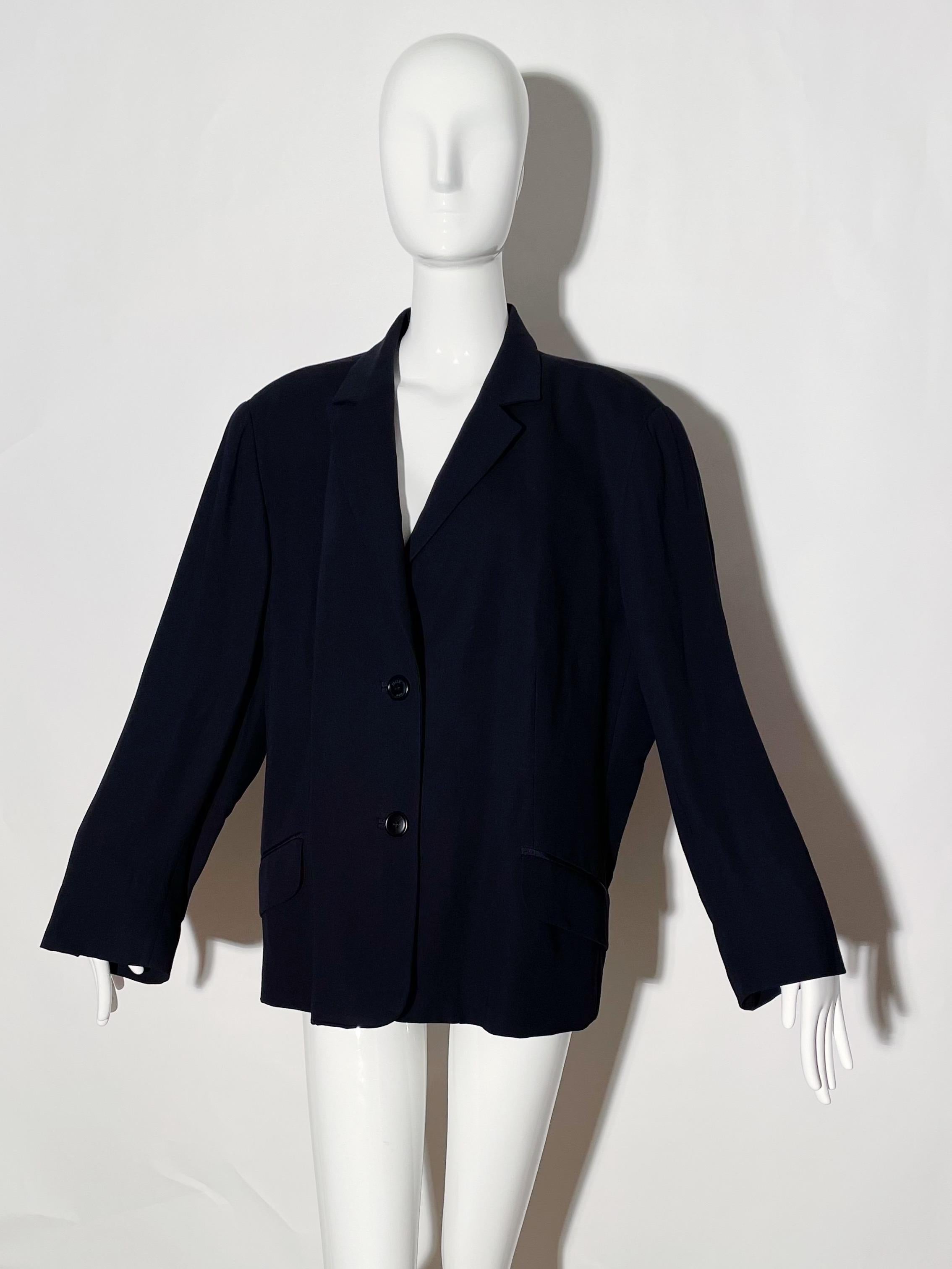Navy blazer. Front buttons. Front pockets. Lapel. Lined. Shoulder pads. Wool and viscose blend. Made in Italy. 
*Condition: Excellent vintage condition. No visible Flaws.

Measurements Taken Laying Flat (inches)—
Shoulder to Shoulder: 18 in.
Sleeve