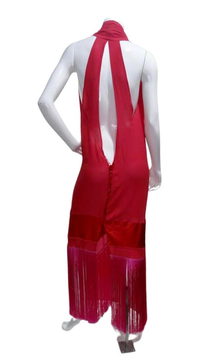 Add this sexy number to your collection! This 90s duster style dress is crafted from vibrant pink silk and features an asymmetrical hem with hot pink fringe, velvet buttons down the front/back, and a stunningly draped front v-neck and open back.