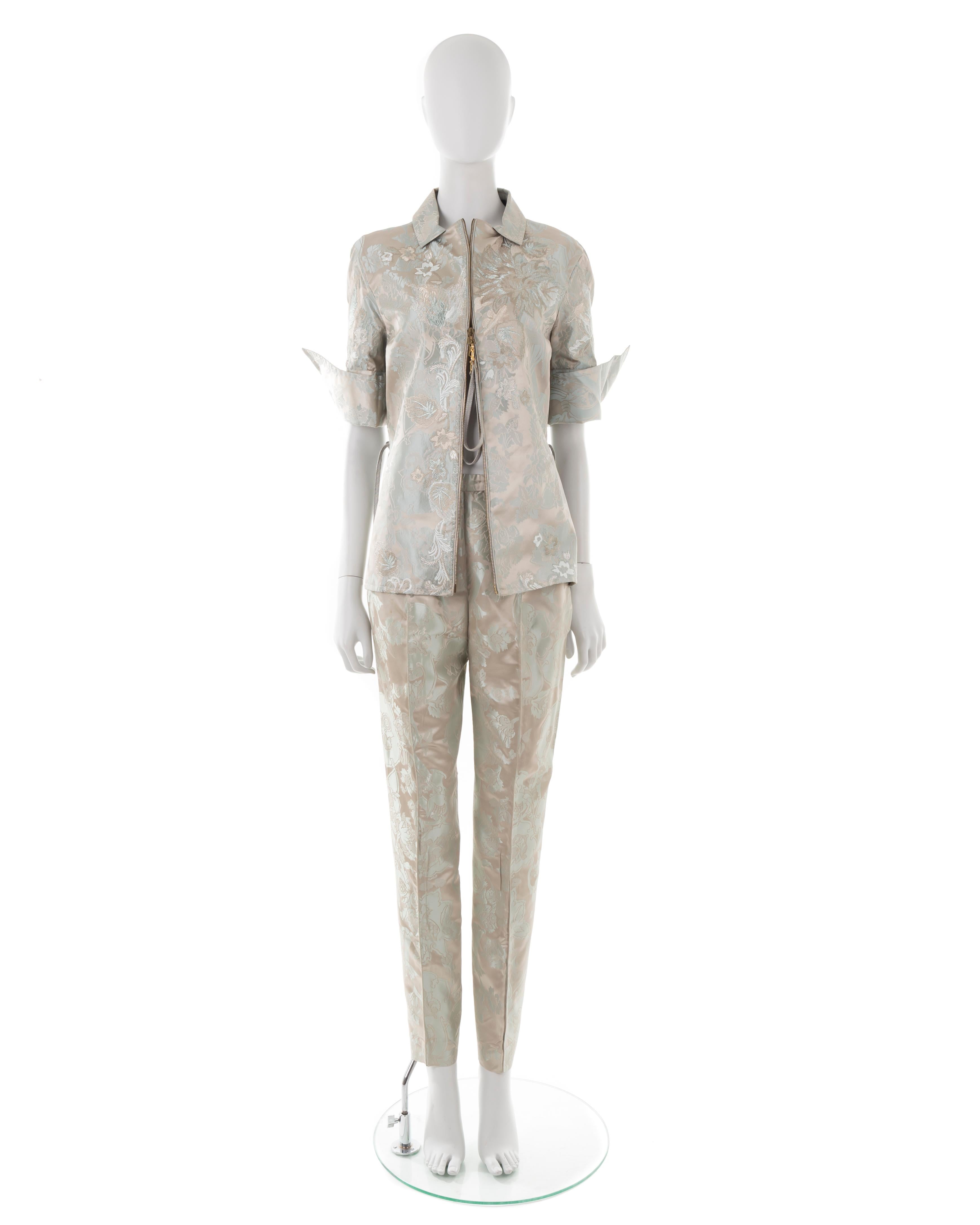 - Grey silk suit (jacket + pants)
- Silver jacquard floral print and embroideries
- 3/4 sleeves with back slit
- Side slits with ties
- Straight pleated pants
- Size label removed, fits S
