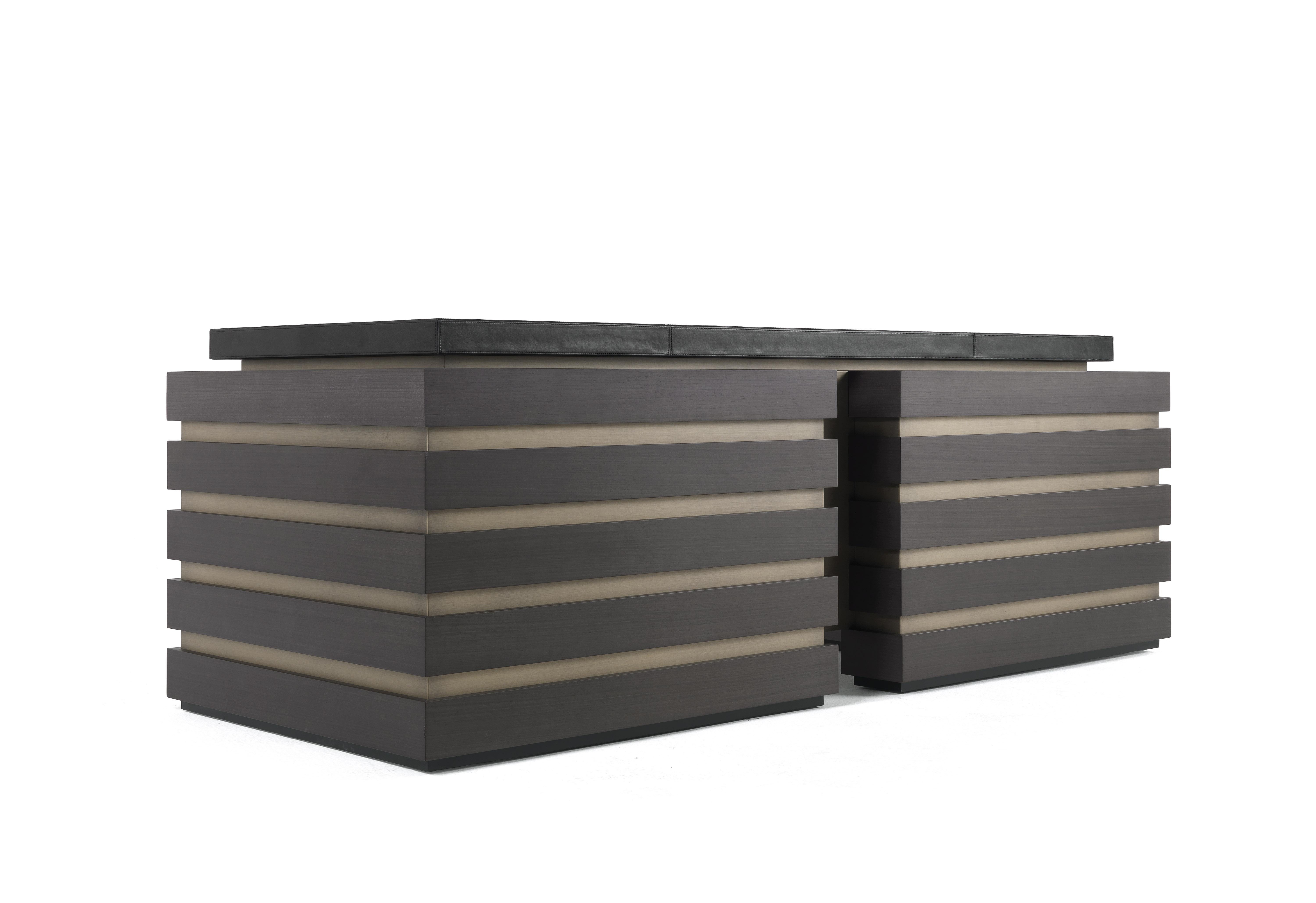 Elegant, functional and comfortable, the Sean desk plays the leading role in the office environment. Made in Tay wood tinted smoky grey, it features inserts with a bronzed finish and a top upholstered in leather that lends the desk a feeling of