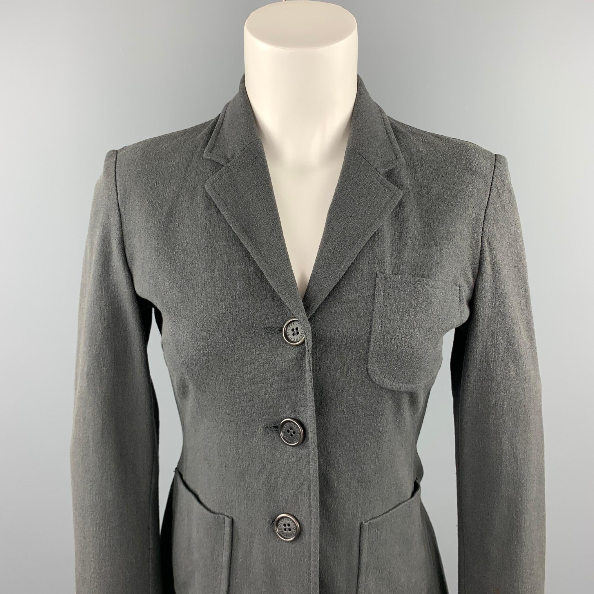 GIANFRANCO FERRE blazer comes in a slate material featuring a notch lapel, patch pockets, and a buttoned closure. Made in Italy.

Very Good Pre-Owned Condition.
Marked: US 6

Measurements:

Shoulder: 15 in. 
Bust: 34 in. 
Sleeve: 22 in. 
Length: 23