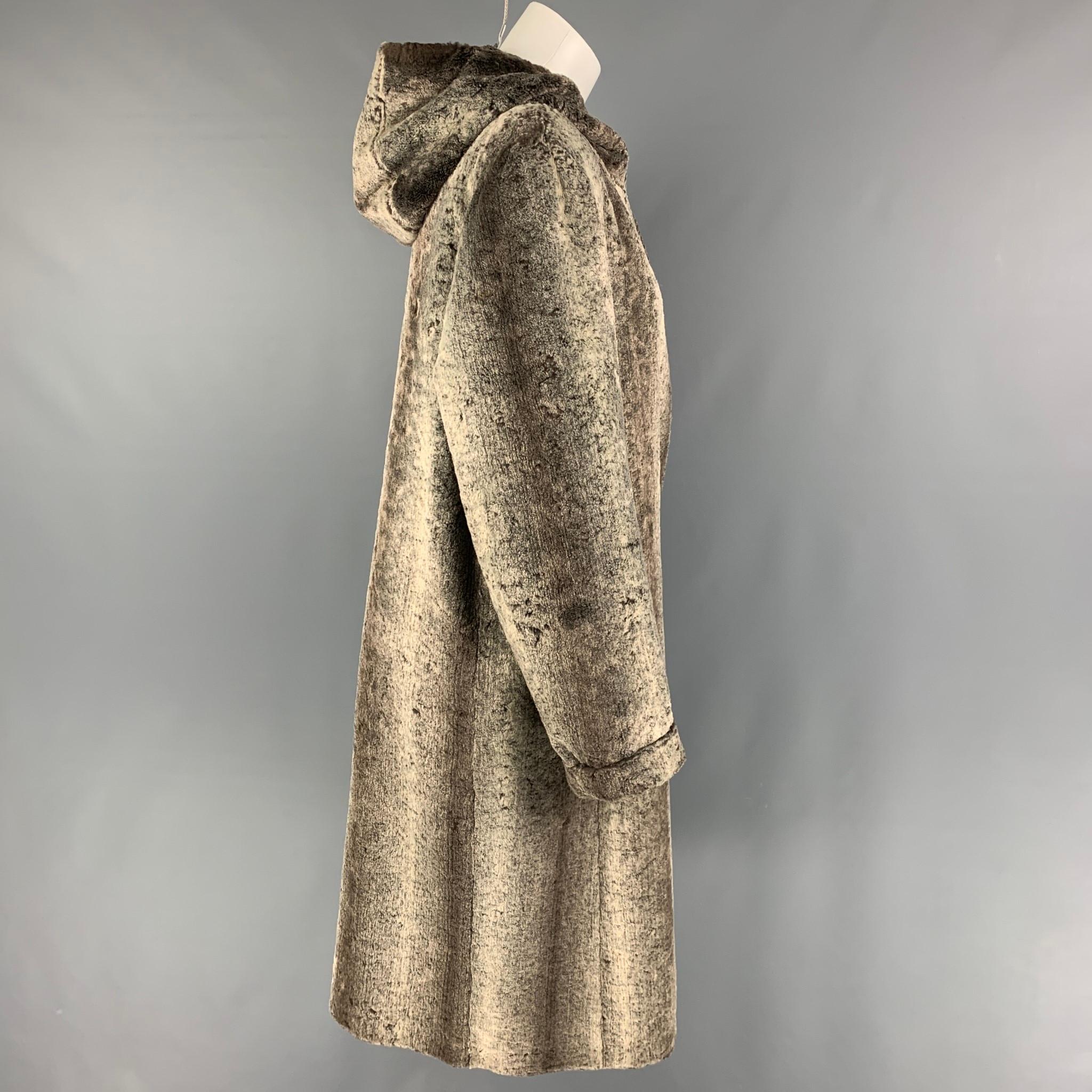 GIANFRANCO FERRE coat comes in a taupe viscose faux fur featuring a hooded style, slit pockets, and a hook & loop closure. 

Good Pre-Owned Condition. Missing a hook & loop.
Marked: 42

Measurements:

Shoulder: 17 in.
Bust: 41 in.
Sleeve: 25.5