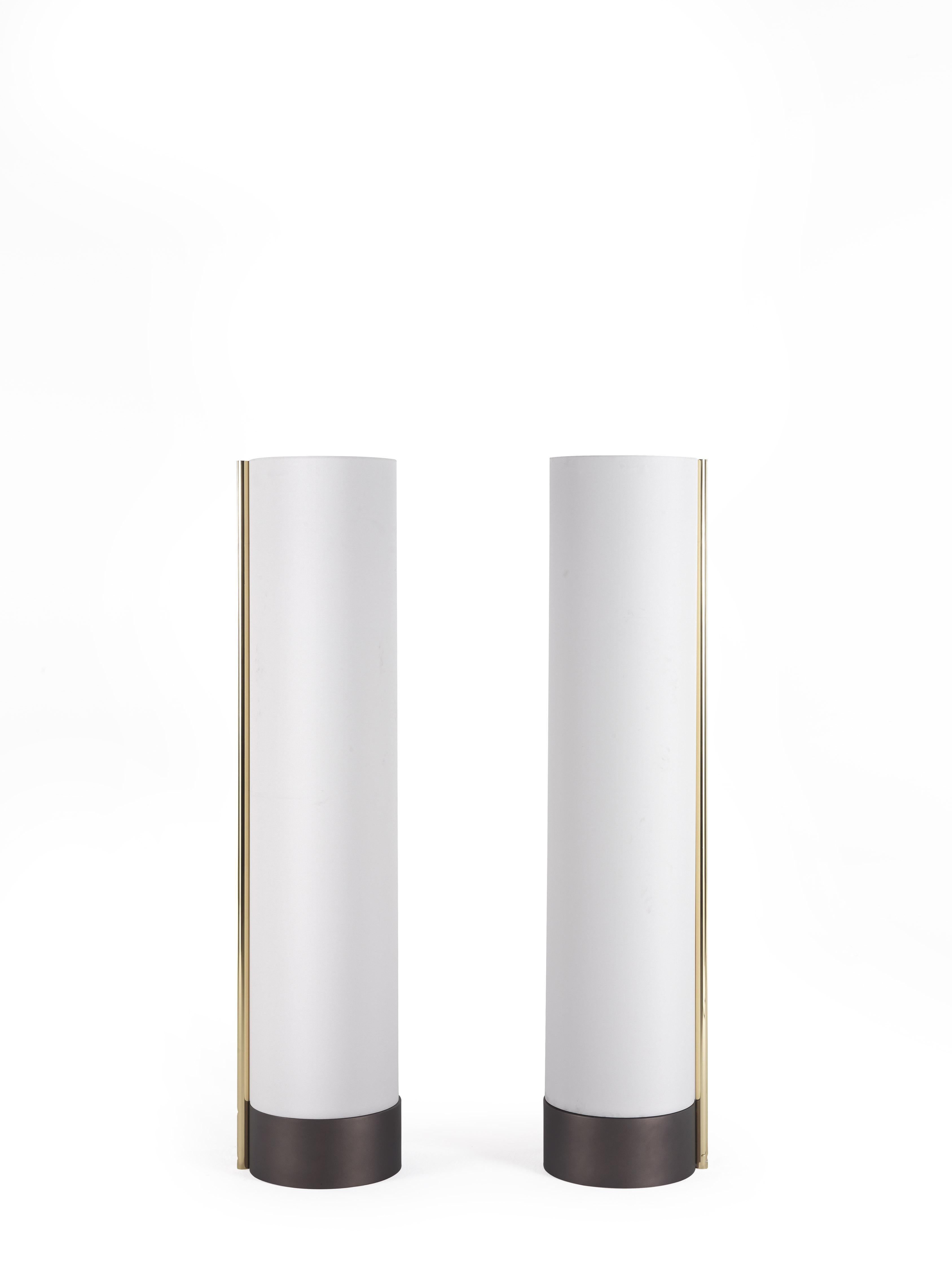 Base in metal with dark bronzed finishing. Shade in white fabric with bar in glossy brass.