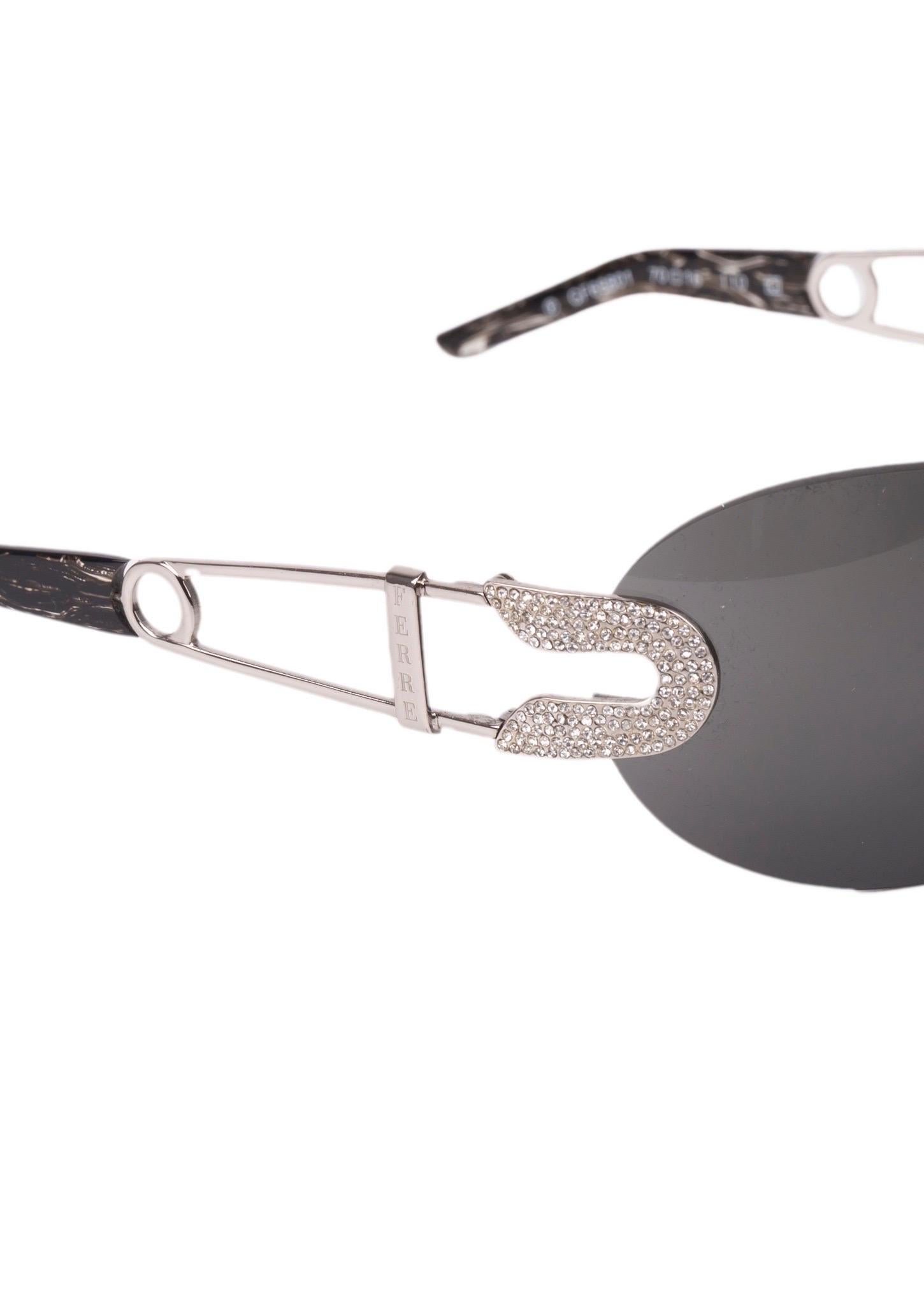 - Rimless sunglasses
- Swarovski encrusted “safety pin” temple
- Swarovski encrusted nose bridge
- Black lenses
- Comes with original case
