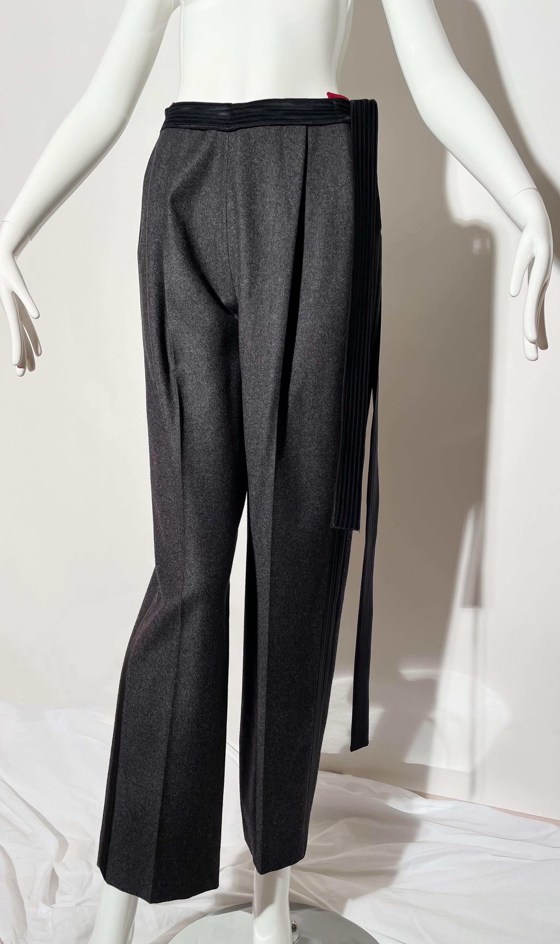 Grey trouser. Tuxedo stripe on side. Multiuse side straps. Wool. Made in Italy. 
*Condition: excellent vintage condition. No visible flaws.

Measurements Taken Laying Flat (inches)—
Waist: 26 in.
Hip: 34 in.
Rise: 13 in.
Inseam:  28.5 in.
Marked