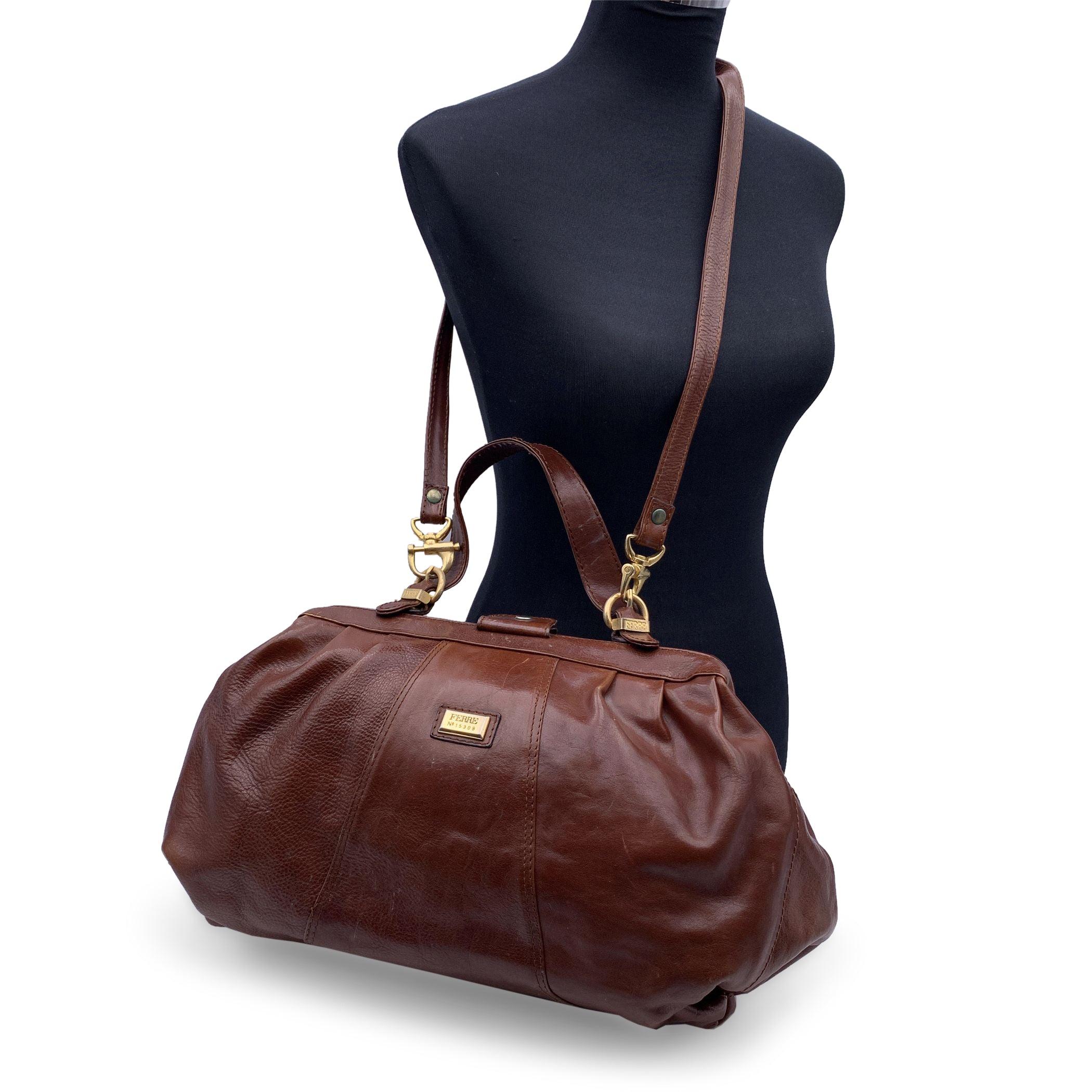 Beautiful Vintage Gianfranco Ferre brown leather doctor bag. Brown leather and gold metal hardware. Top carry handle and removable shoulder strap. Framed top with button closure. Satin signature lining. 1 side zip pocket inside. Giangraco Ferre tag