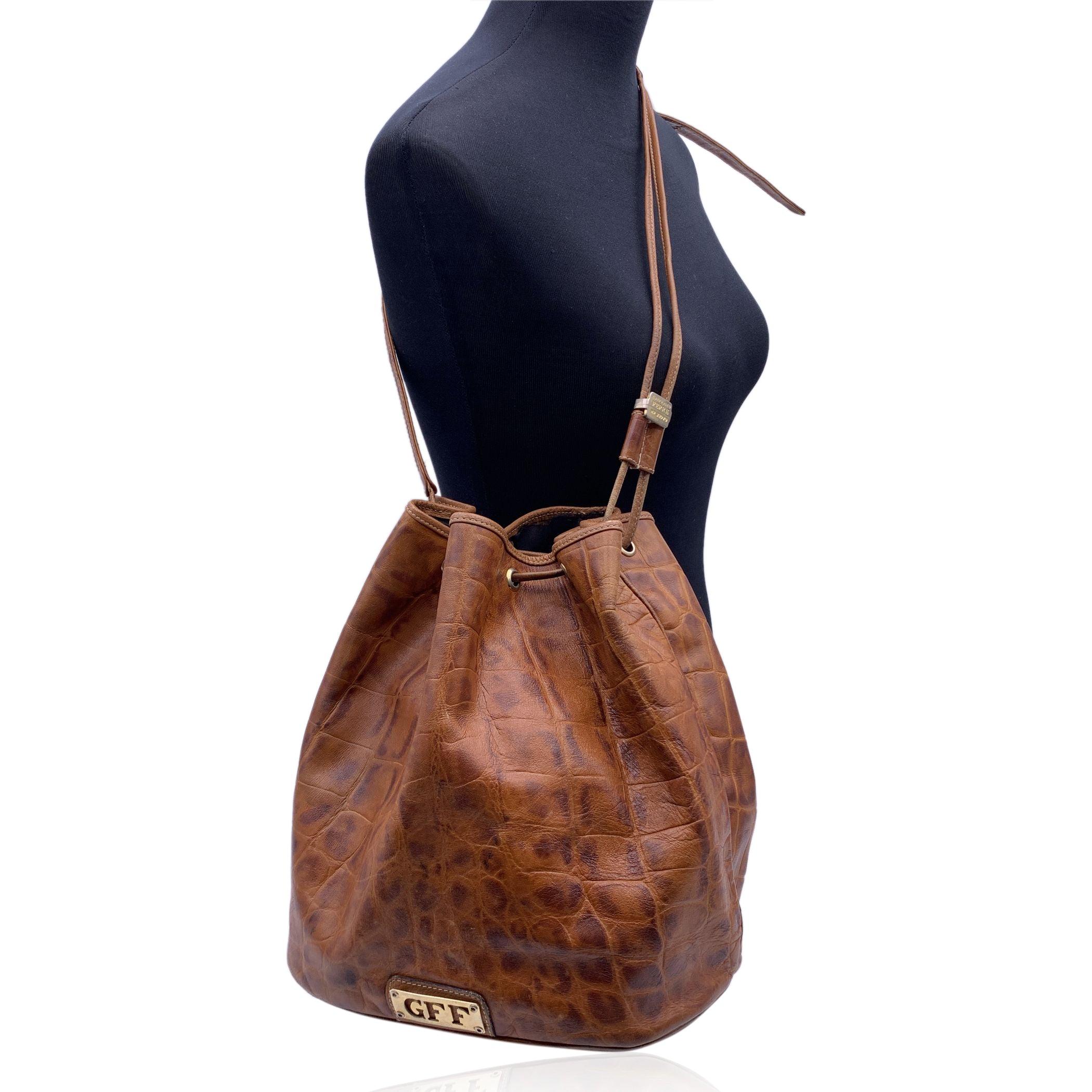 Beautiful Vintage Gianfranco Ferre brown leather bucket bag. Drawstring closure. Black canvas lining. Adjustable shoulder strap. 1 side zip pocket inside . Condition B - VERY GOOD Gently used. Some normal wear of use on leather. The logo plate seems
