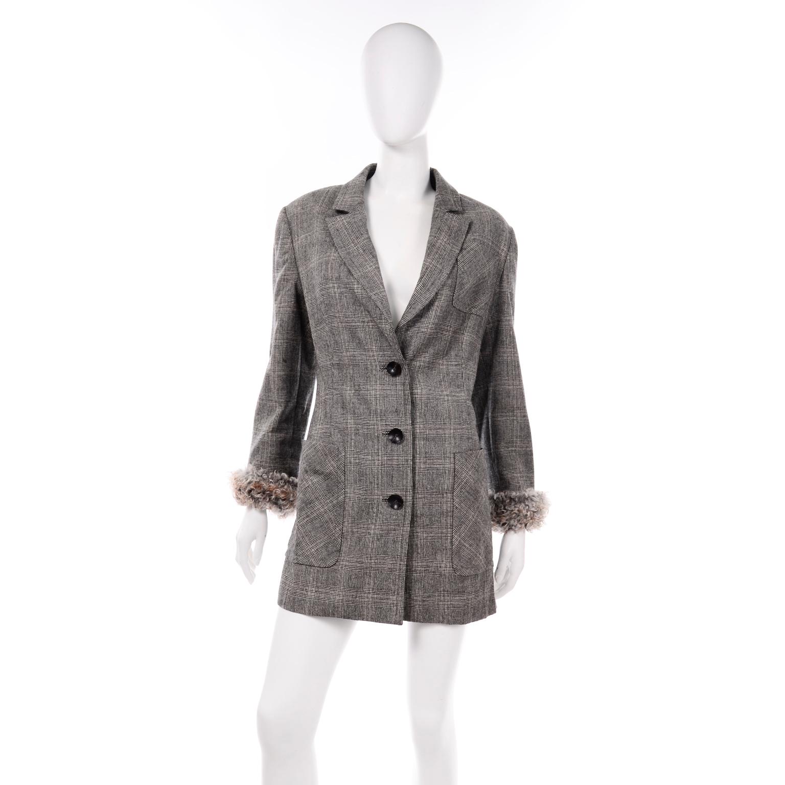 This Gianfranco Ferre grey plaid wool longline blazer jacket will make a great Fall and Winter staple! The plaid wool fabric is black, grey, white, and light brown. There are 2 functional patch pockets with a patch breast pocket and there is a