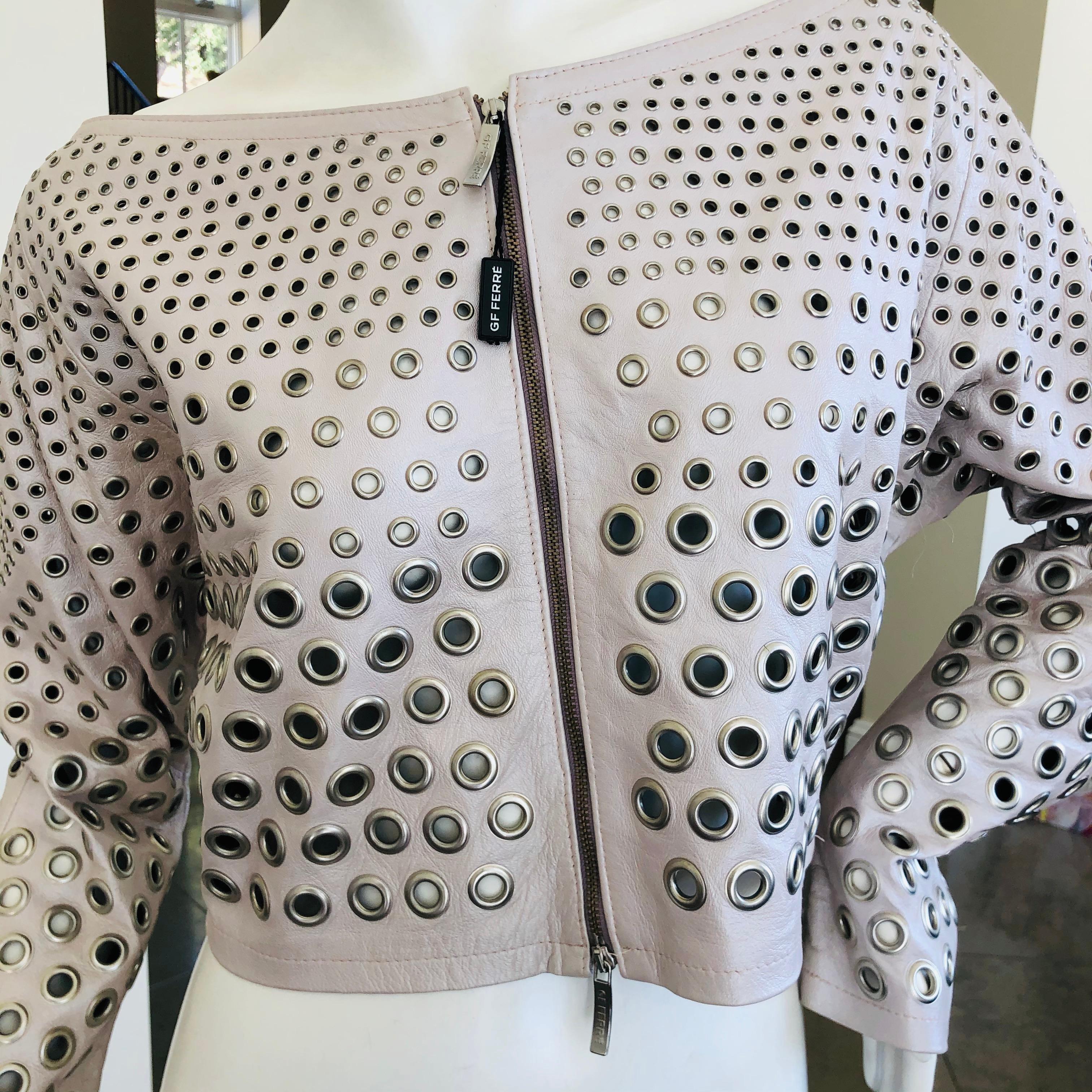 Gianfranco Ferre Vintage Silver Leather Cropped Jacket with Graduating Grommets.
This is a wonderful piece, slightly off the shoulder low cut collar, and covered in graduating sized grommet's.
Size Small
Bust 40