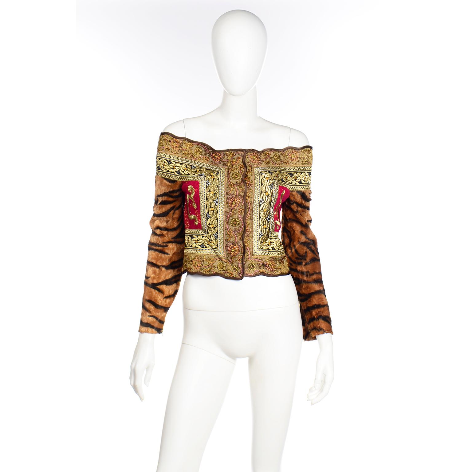 This deadstock Fall / Winter 1989 Gianfranco Ferre off shoulder jacket style top with faux tiger fur sleeves is fantastic! This exceptional, rare vintage top has metallic embroidery, beautiful tapestry, red knit with gold embroidery and a scalloped
