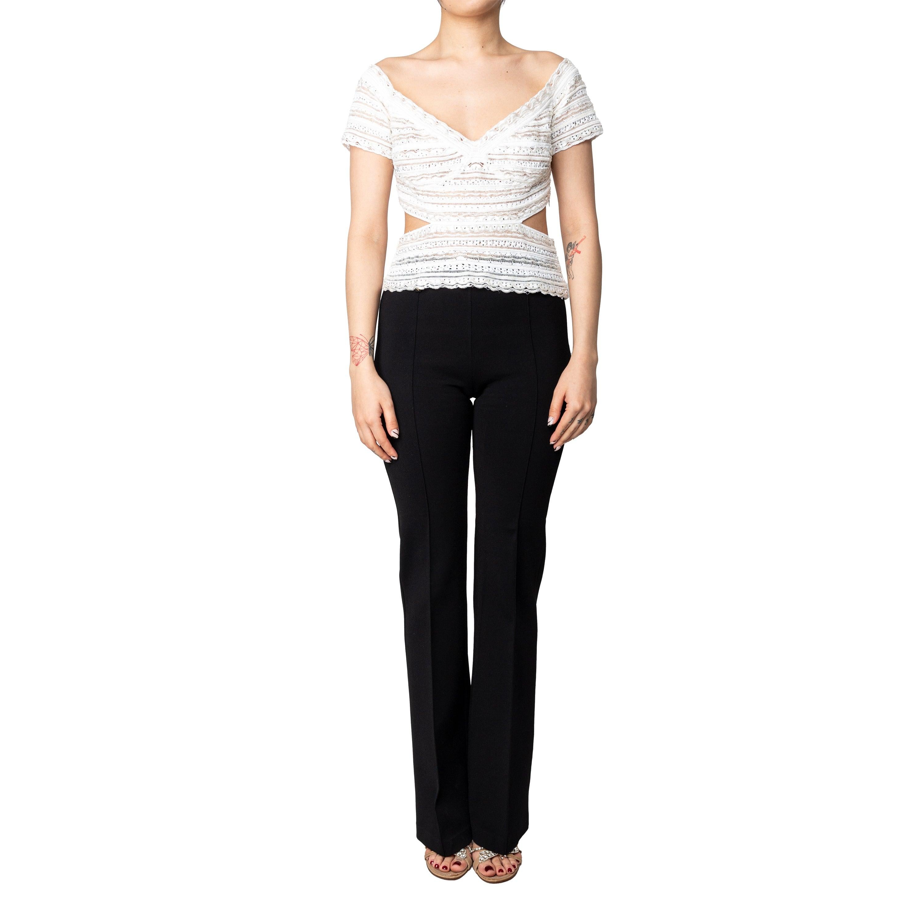 This one-of-a-kind Gianfranco Ferré top features lace and sequined details as well as flattering triangle cut outs in the waist and back areas. It can be styled with a skirt or pants for an elegant summertime look.
 
 Bust:42;Waist:34;Length:42