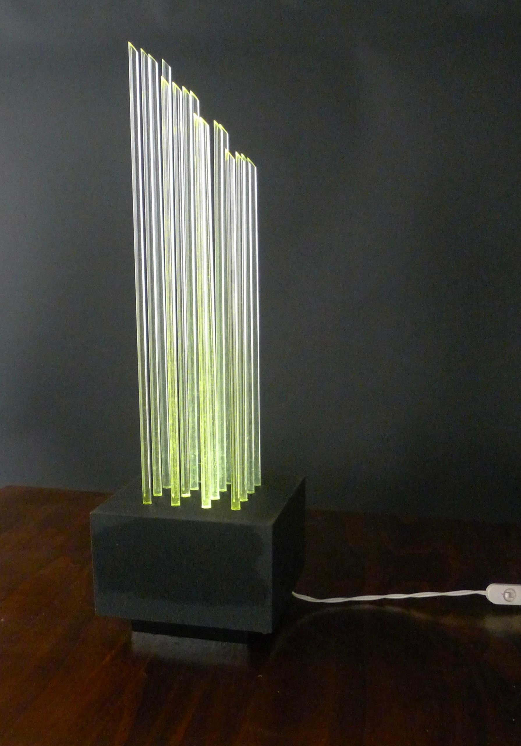 Stunning Pop Art Table Lamp, comprising 16 plexiglass rods illuminated through circular holes in the black aluminium base.

Believed to be a model titled Divieto, attributed to Gianfranco Fini and Fabrizio Cocchia, possibly for New Lamp, though no