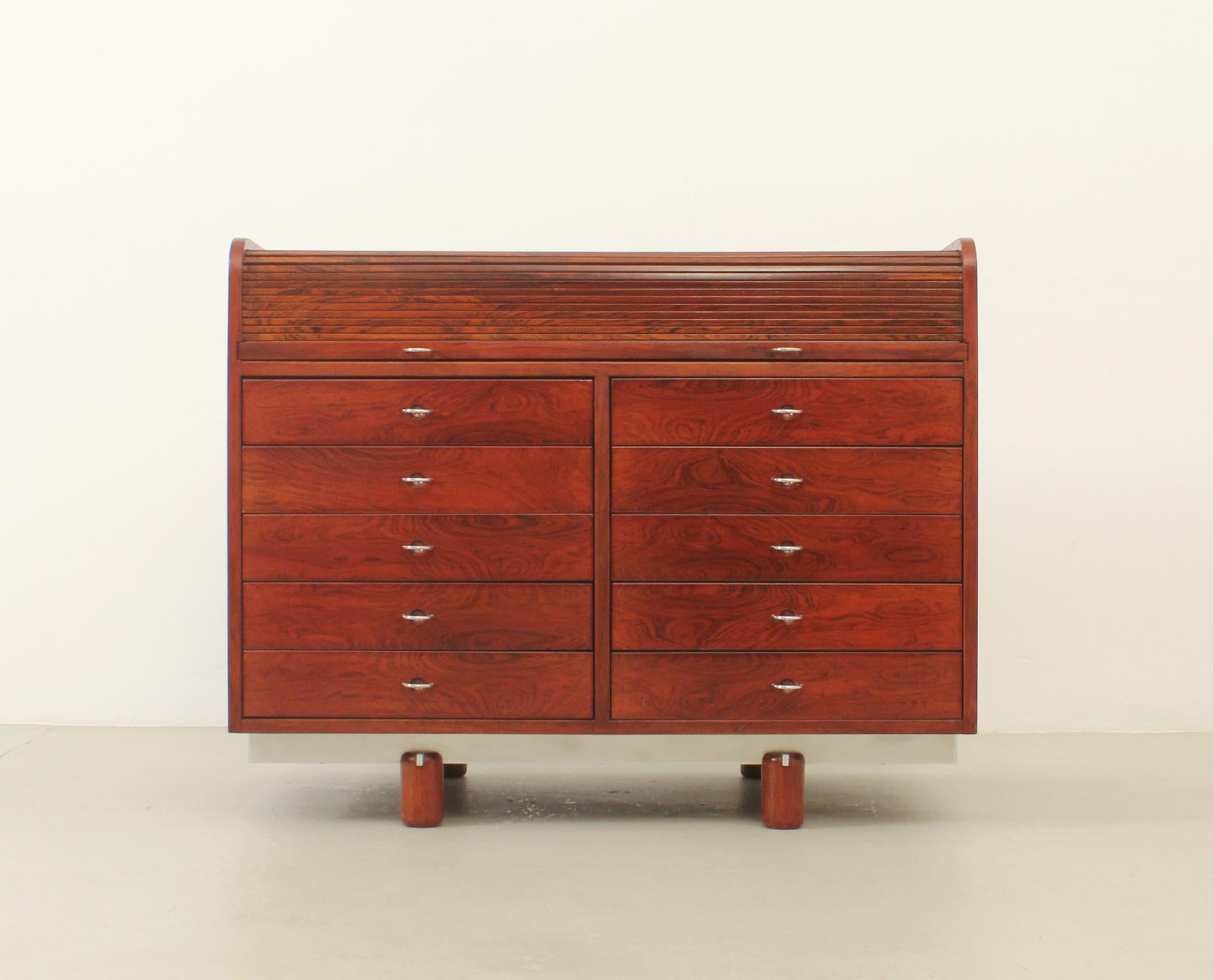 Writing desk model 804 designed in 1961 by Gianfranco Frattini for Bernini, Italy. Tambour top that hides small drawers and a pull out leather writing surface. Front side with ten drawers and four open spaces on back side.