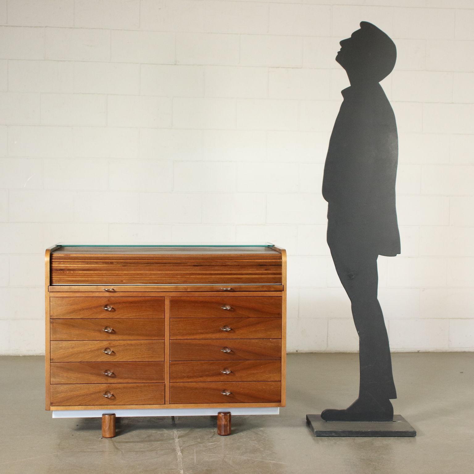 Centre desk with shutter with extractable top; inside drawers and plastic material containers for stationary, solid wood (front drawers and shutter) and walnut veneer, top upholstered in leather, glass shelf.