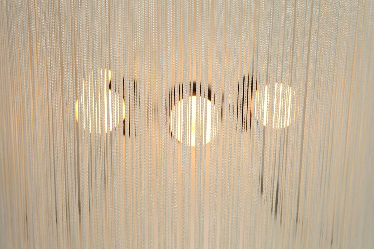 Model 597 table lamp by Gianfranco Frattini produced by Arteluce. Designed in 1961 this innovative lamp combined a central aluminum inverted conical shaped form with 6 central light sockets and one uplight. Ivory rayon fringe suspended in the top