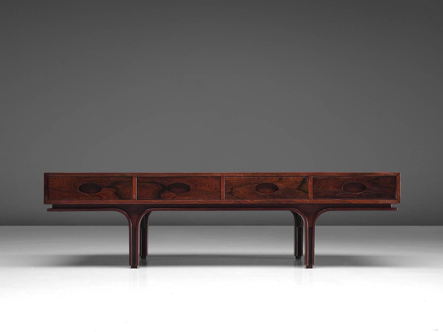 Gianfranco Frattini for Bernini, low board or coffee table, rosewood, Italy, 1960s.

This coffee table in rosewood is designed by Frattini. It features the typical design traits of Frattini such as the four drawers with stretched handle but also the