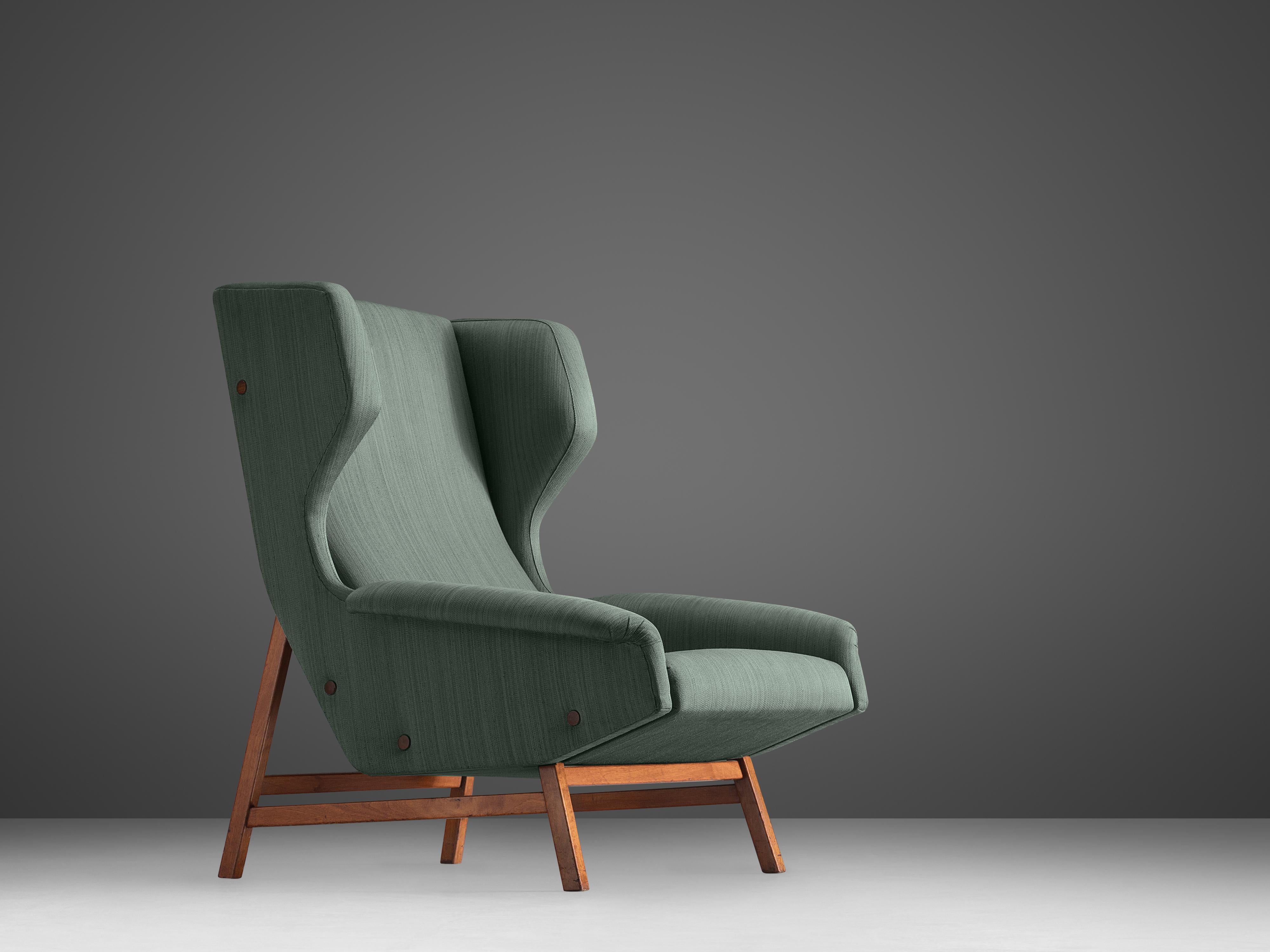 Gianfranco Frattini for Cassina, lounge chair model 877, fabric, teak, Italy, 1959

This grand lounge chair is based on a solid construction, featuring strict lines and angular shapes. While the seat convinces with its bulky and voluminous