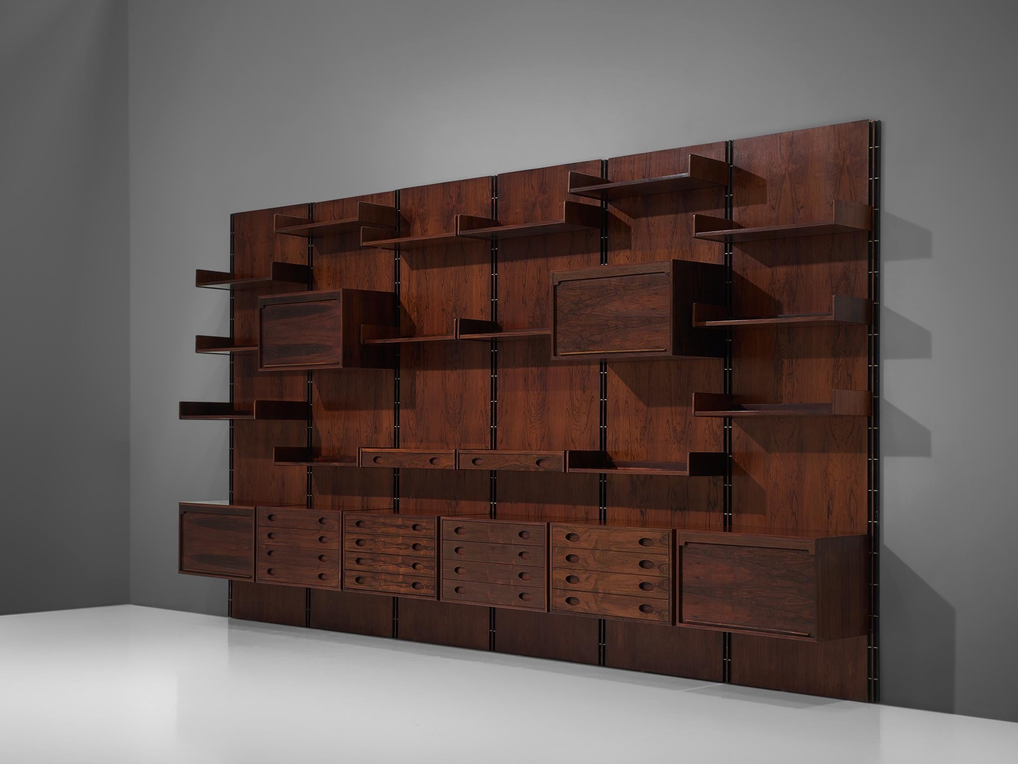 Gianfranco Frattini for Bernini, wall unit, rosewood, Italy, 1960s

This large 4.8mt/15.7ft wall unit is designed by the Italian designer Gianfranco Frattini. The cabinet consists of six panels with various different storage facilities. There are