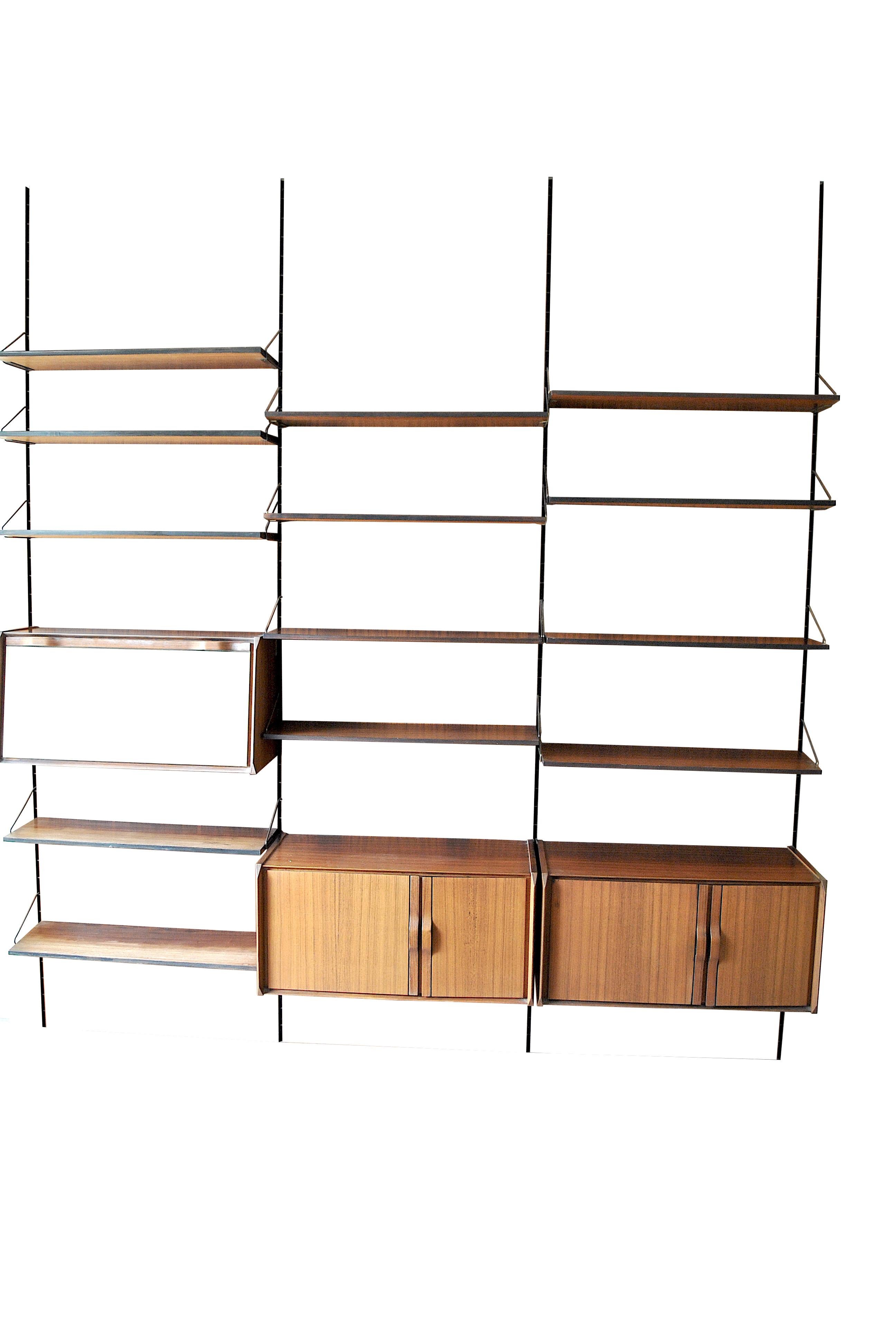 Italian midcentury bookcase by Gianfranco Frattini for La Permanente Mobili Cantù, Italy. The bookcase is composed of three modules with three containers and 13 shelves walnut
The bookcase can be mounted in two ways with or without wooden panels as