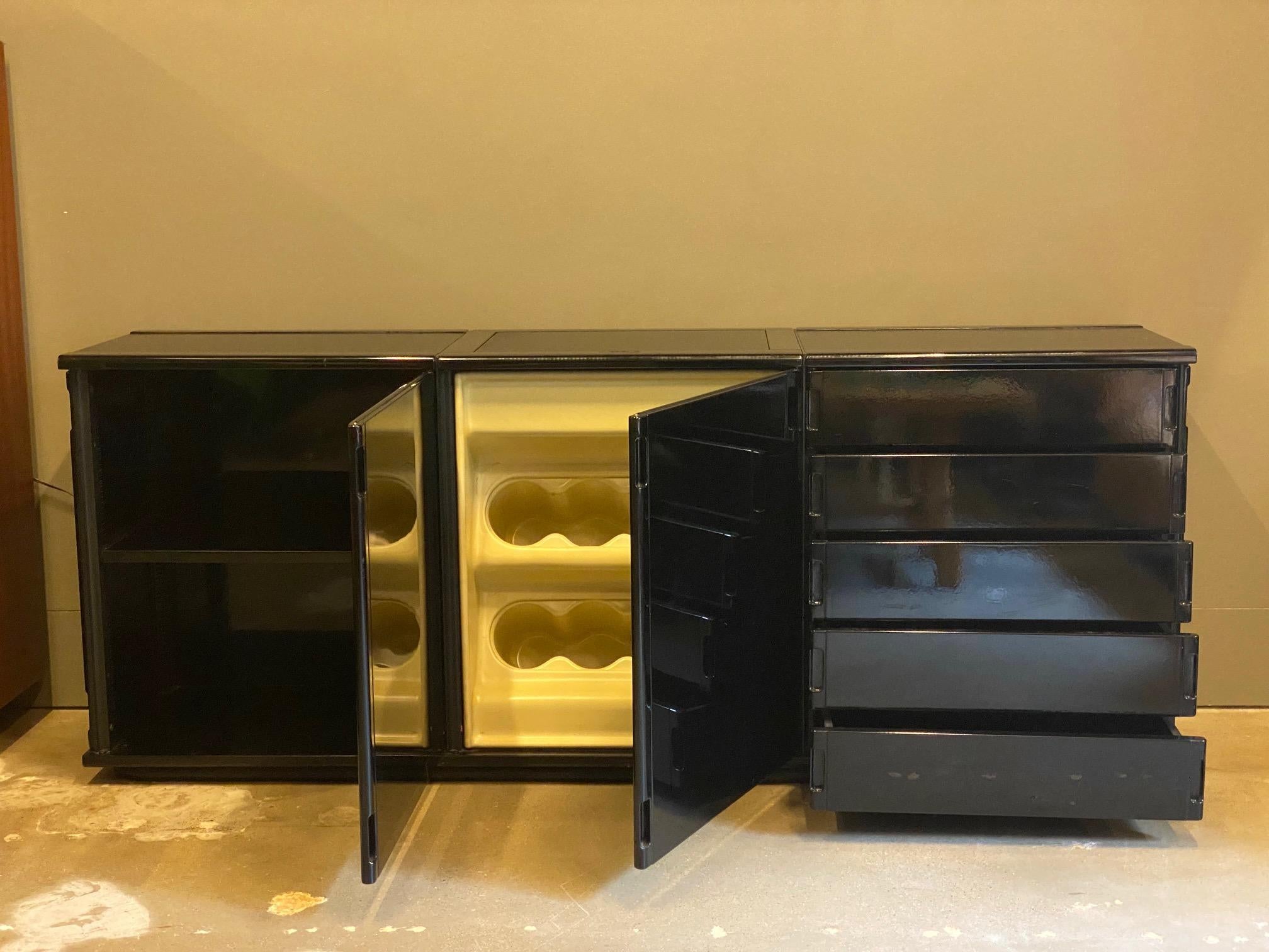 Rare Gianfranco Frattini Larco Series sideboard for Molteni.  Black lacquer and high gloss acrylic surfaces are contrasted with inset matte black panels on the top surface.  Built as a modular designed casegood series, this three piece unit is