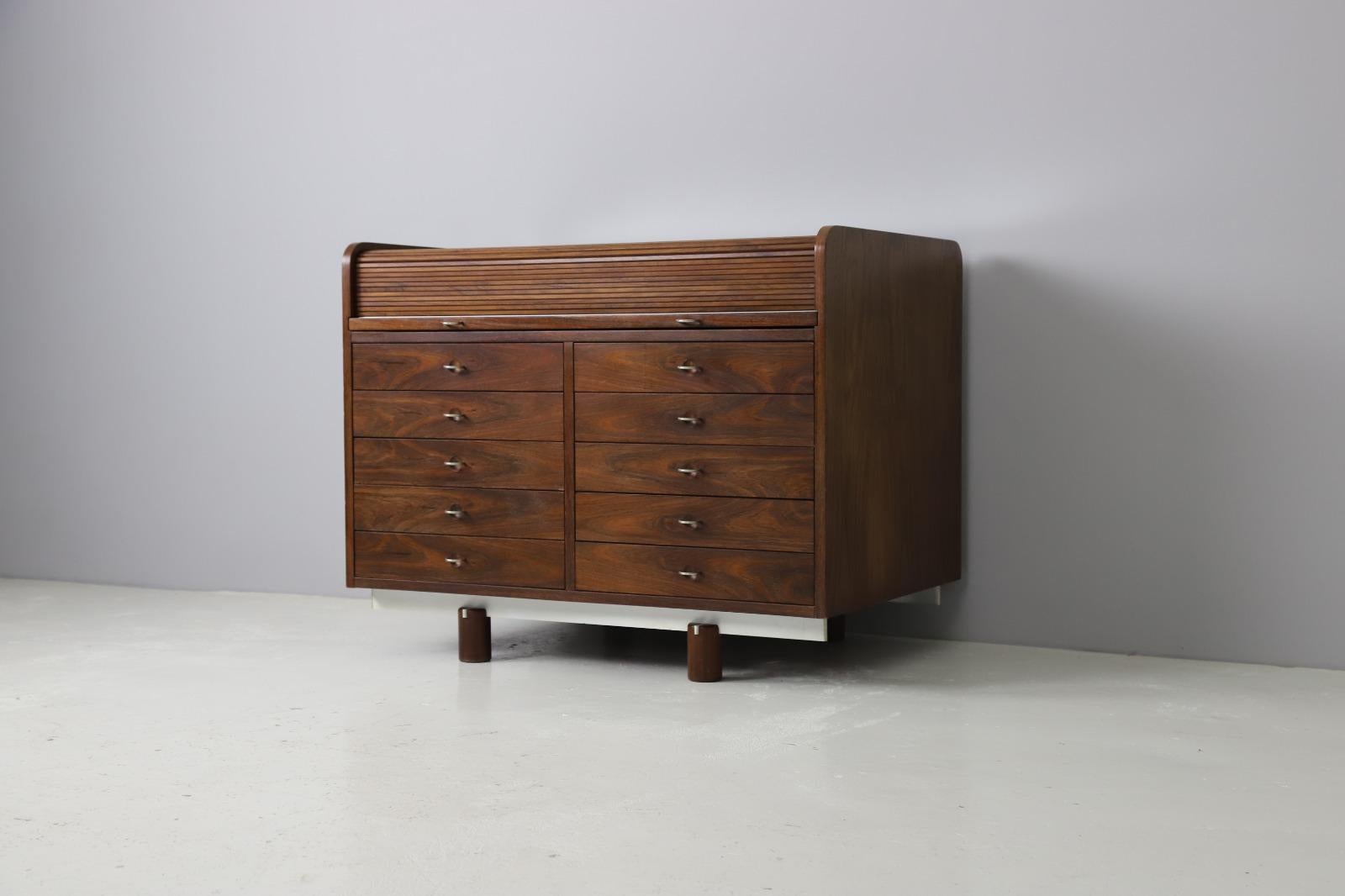 Model 804 roll top secretary designed by Gianfranco Frattini, produced by Bernini, Italy 1962. By pulling the two upper pulls you will access the hidden working space with a leather desk top and small rosewood drawers. This writing desk can be used